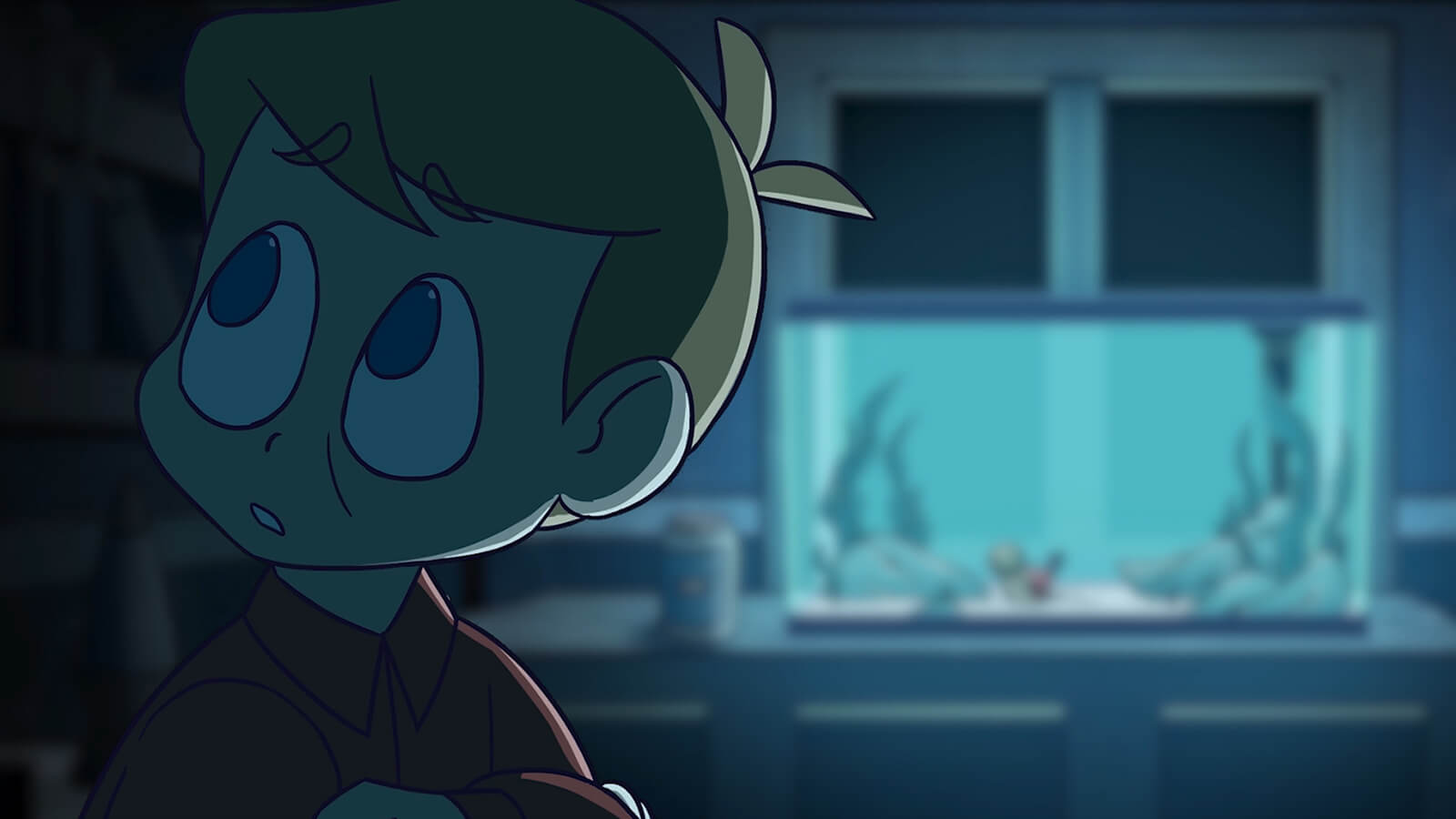 A boy in a darkened room lit by a fish tank.