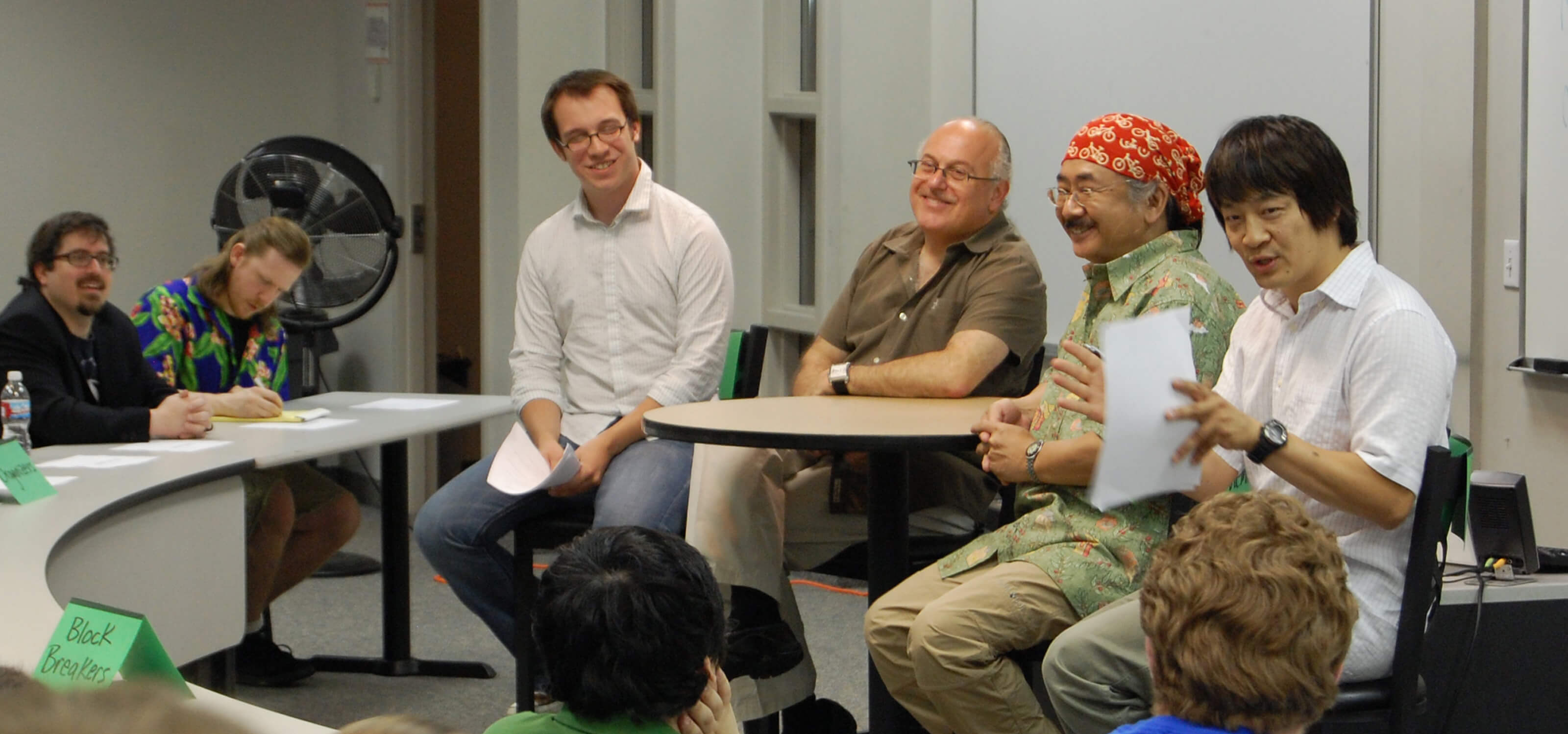 Nobuo Uematsu and Arnie Roth speak to students in a DigiPen classroom
