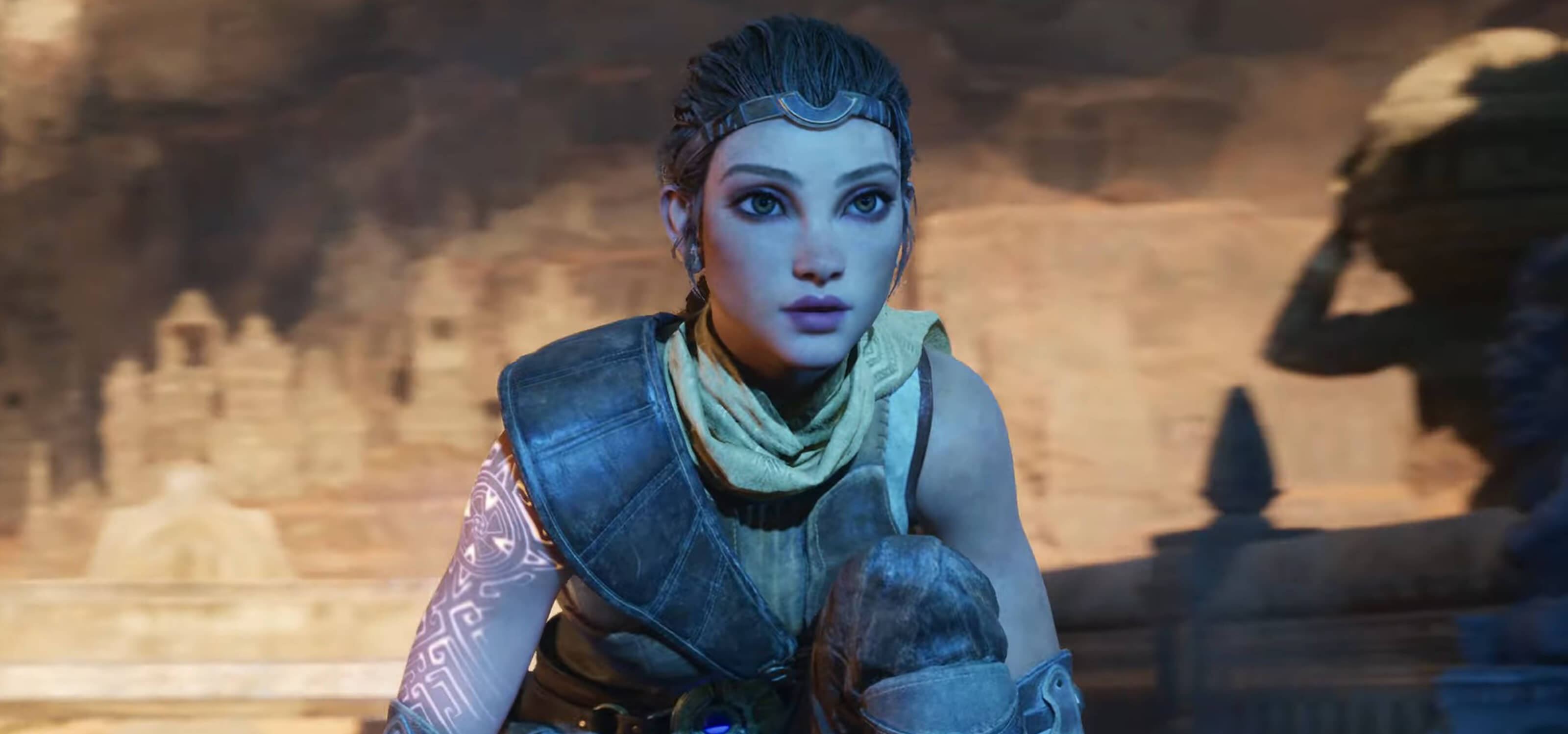 A screenshot, taken from the Unreal Engine 5 demo, of a woman with glowing runes on her arm, crouching in a cave. 