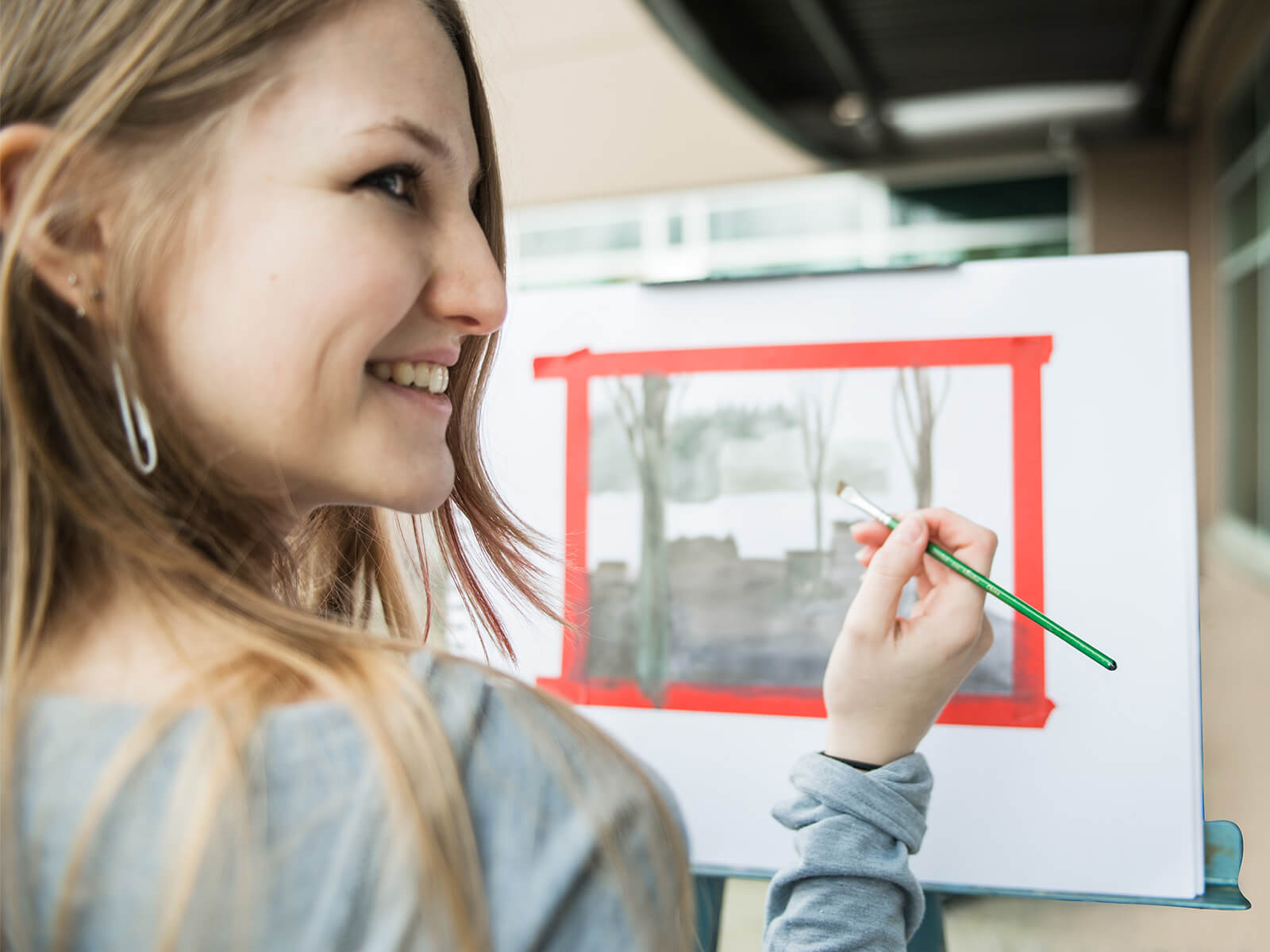 A DigiPen art student paints a watercolor landscape.