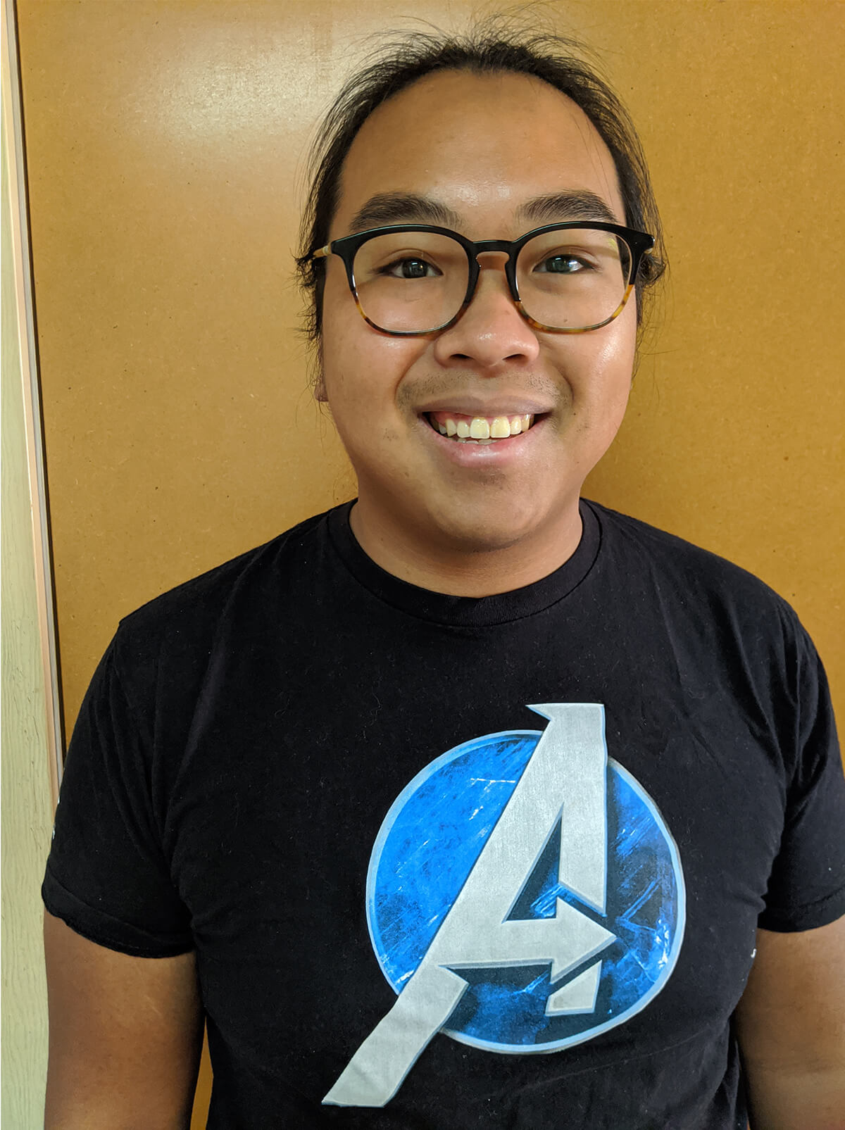 DigiPen graduate Kevin Do poses in an Avengers t-shirt