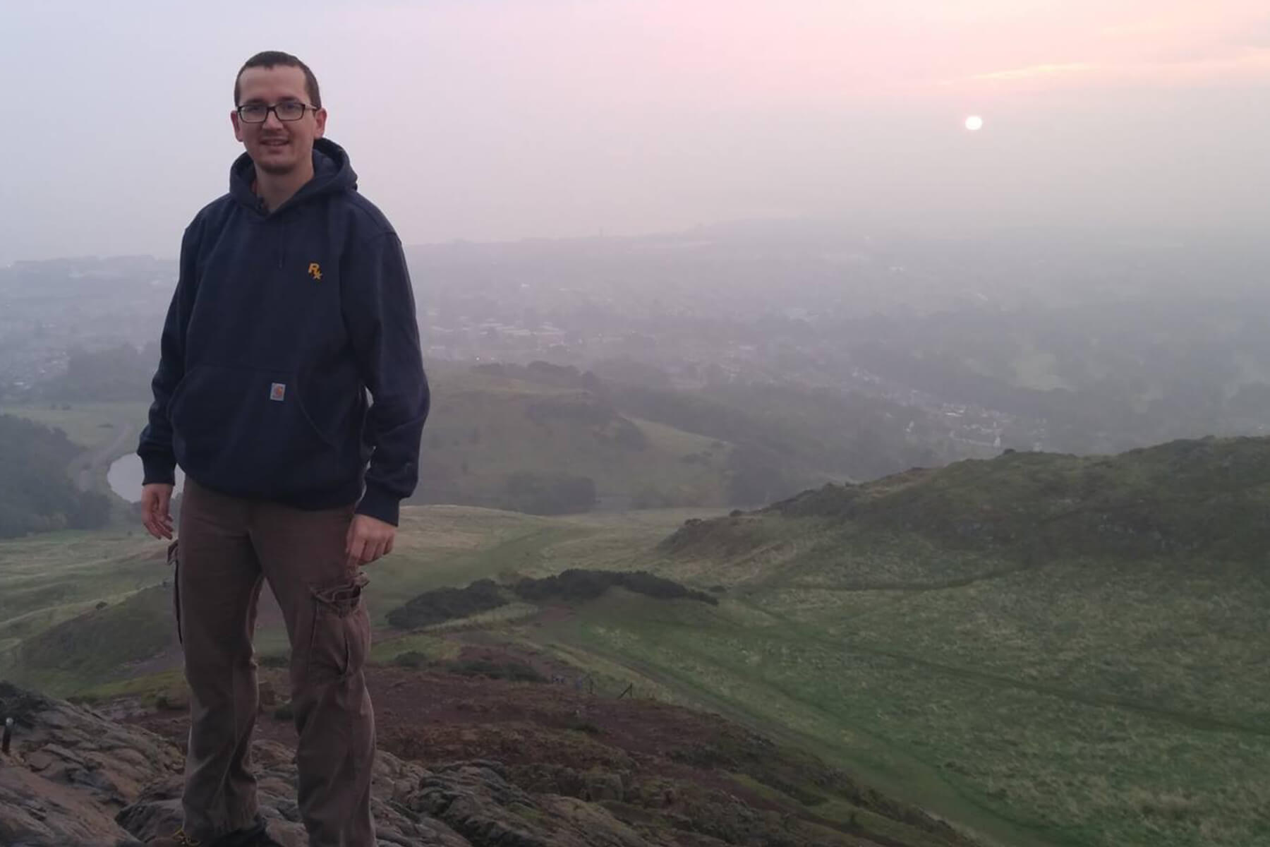 Andy Kibler poses at Arthur's Seat in Scotland