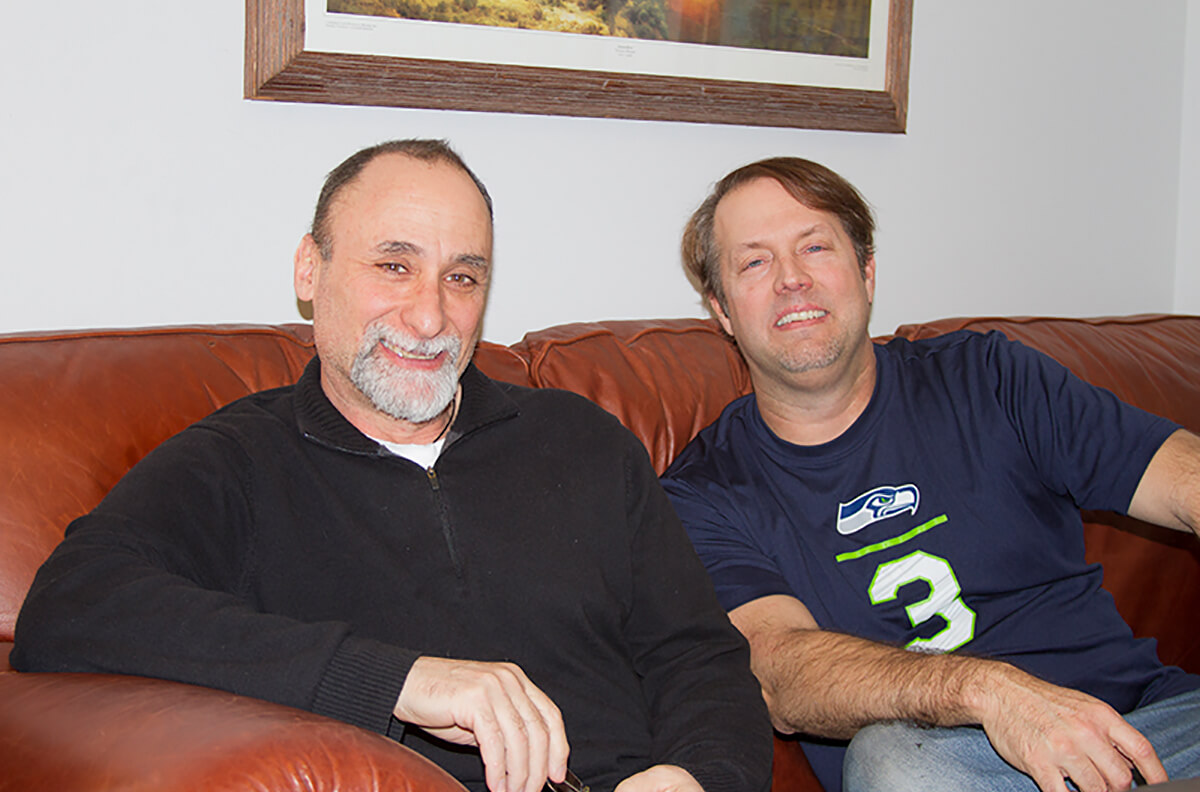 Former Disney animators and current DigiPen professors Anthony De Fato and Richard Morgan smiling on a couch