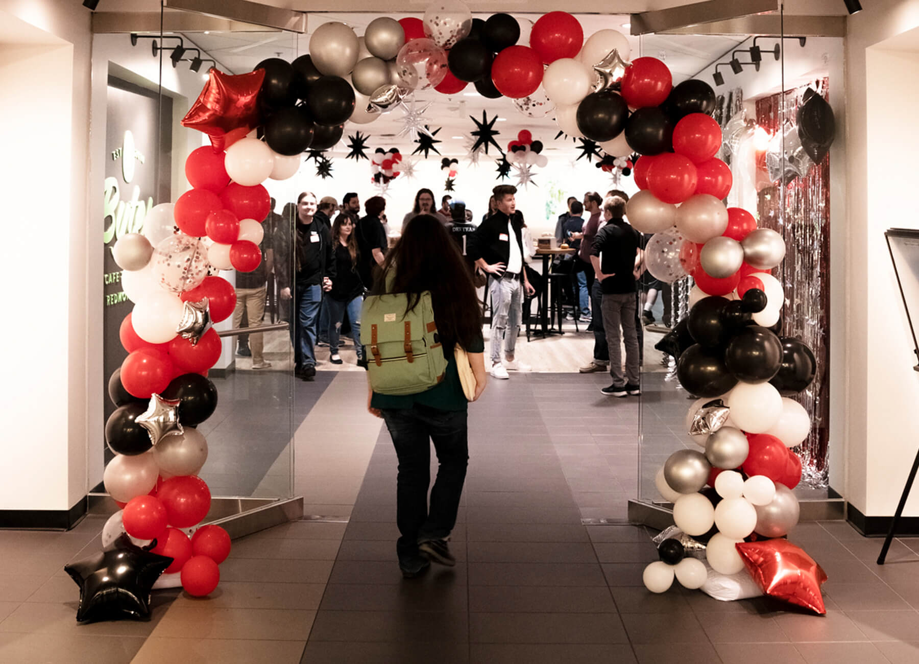 A balloon arch forms over the entrance to the DigiPen Alumni Reunion.