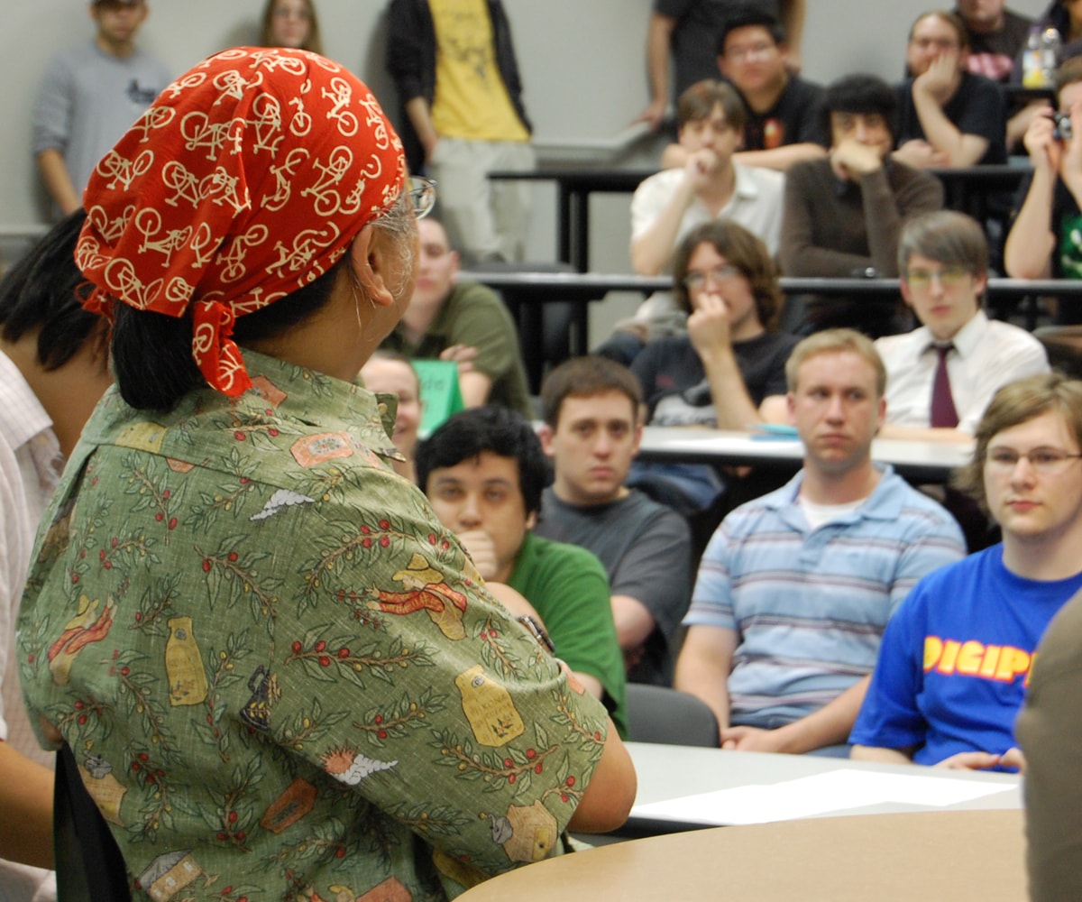 DigiPen students listen intently to Nobuo Uematsue, who's wearing a bicycle-printed head scarf
