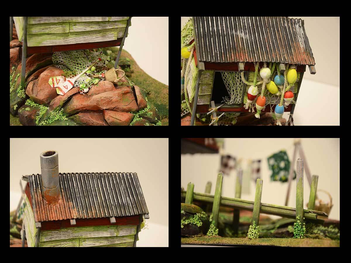 A model of a wooden shack in a swampy environment.