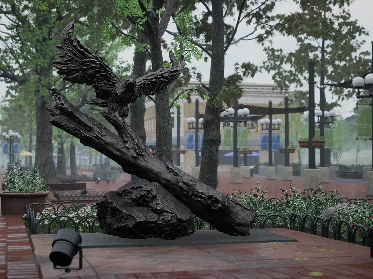 A plaza area on a rainy day with a statue of an eagle.