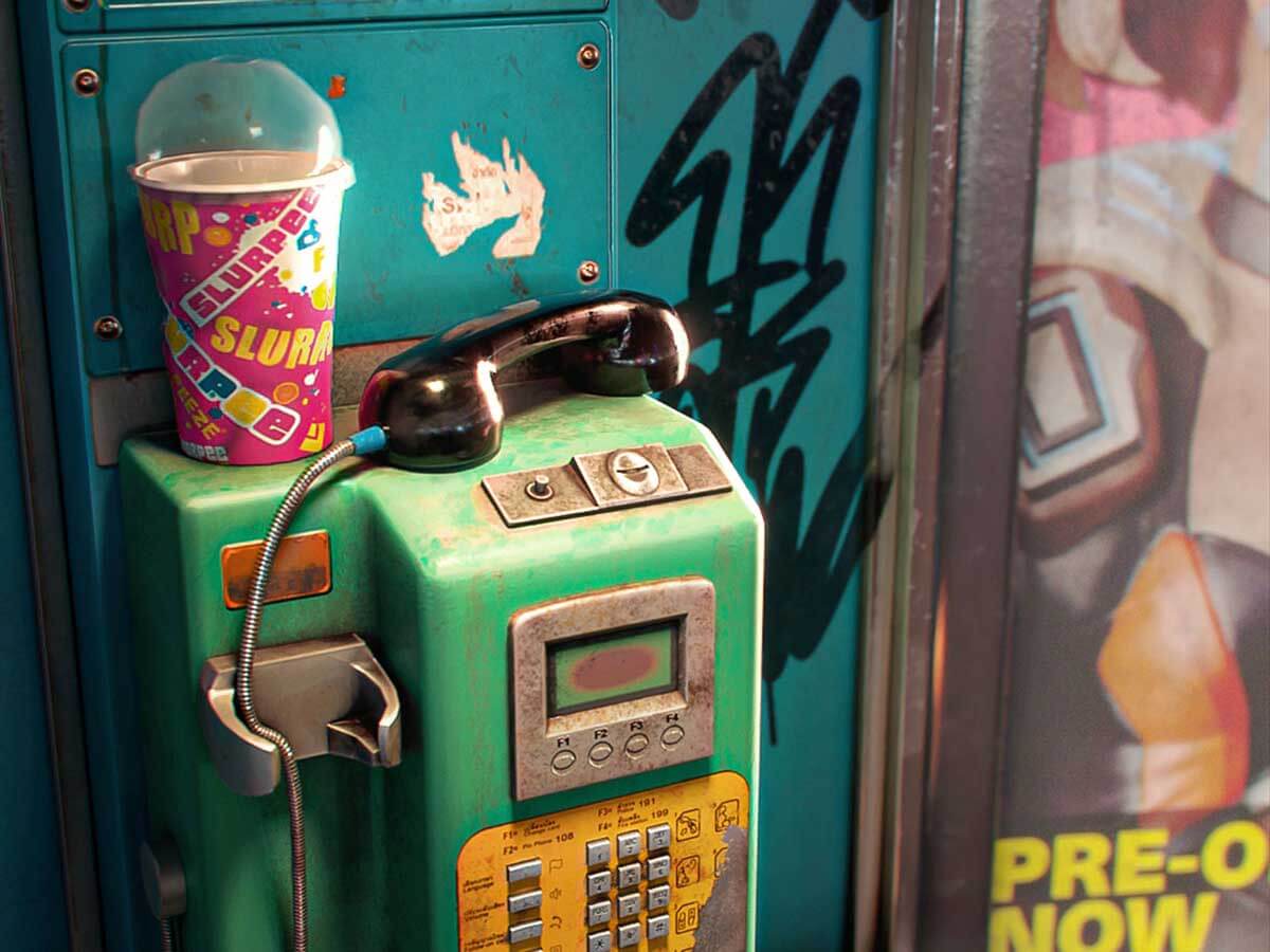 A dirty payphone surrounded by trash and advertisements.