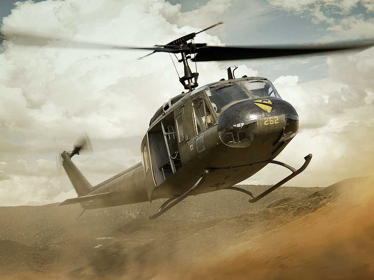 A combat helicopter swooping down in the desert.