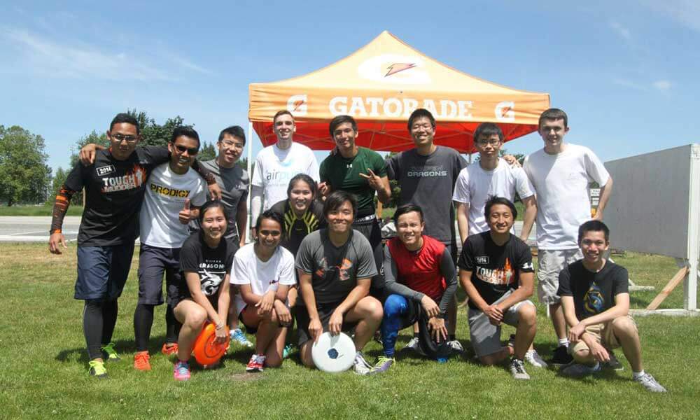 Both Redmond and OIP students pose outside near a tent on a field