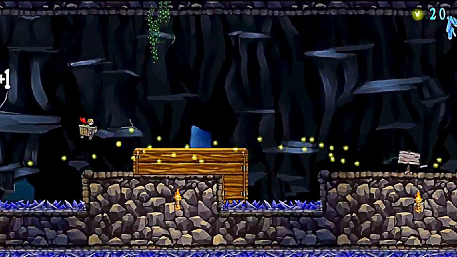 A caped boy riding a mine cart soars through the air in a large underground cavern. 