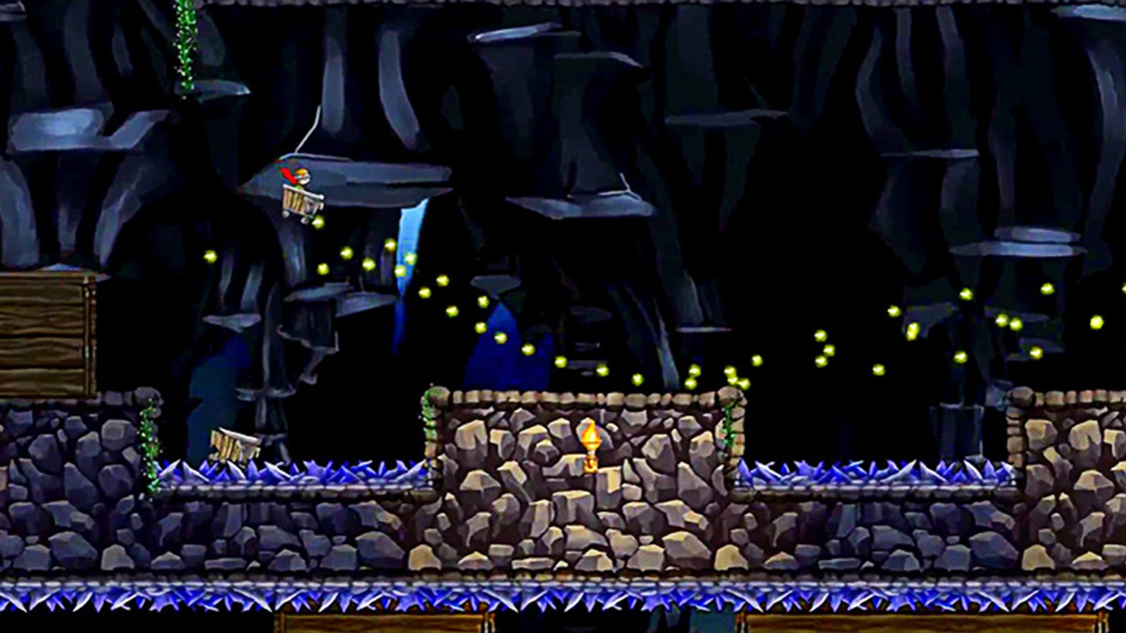 A caped boy riding a mine cart soars through the air in a large underground cavern. 