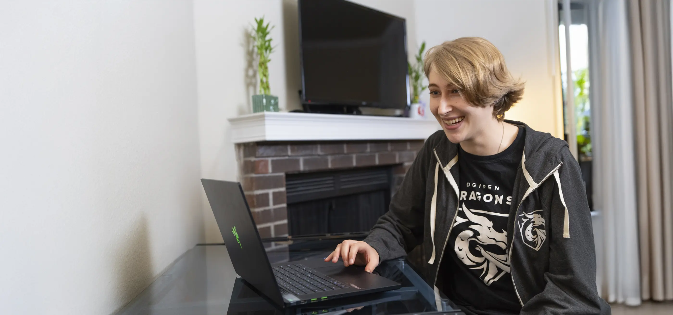 A DigiPen student sits at a desk with a computer.