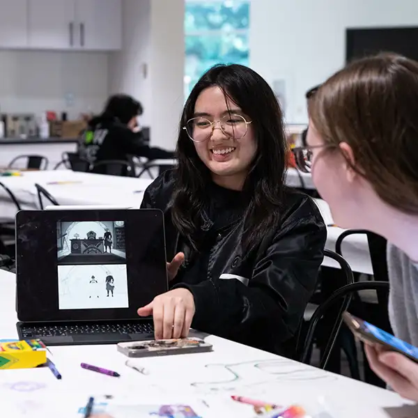 DigiPen student showcases work on her laptop in the Bytes cafe.