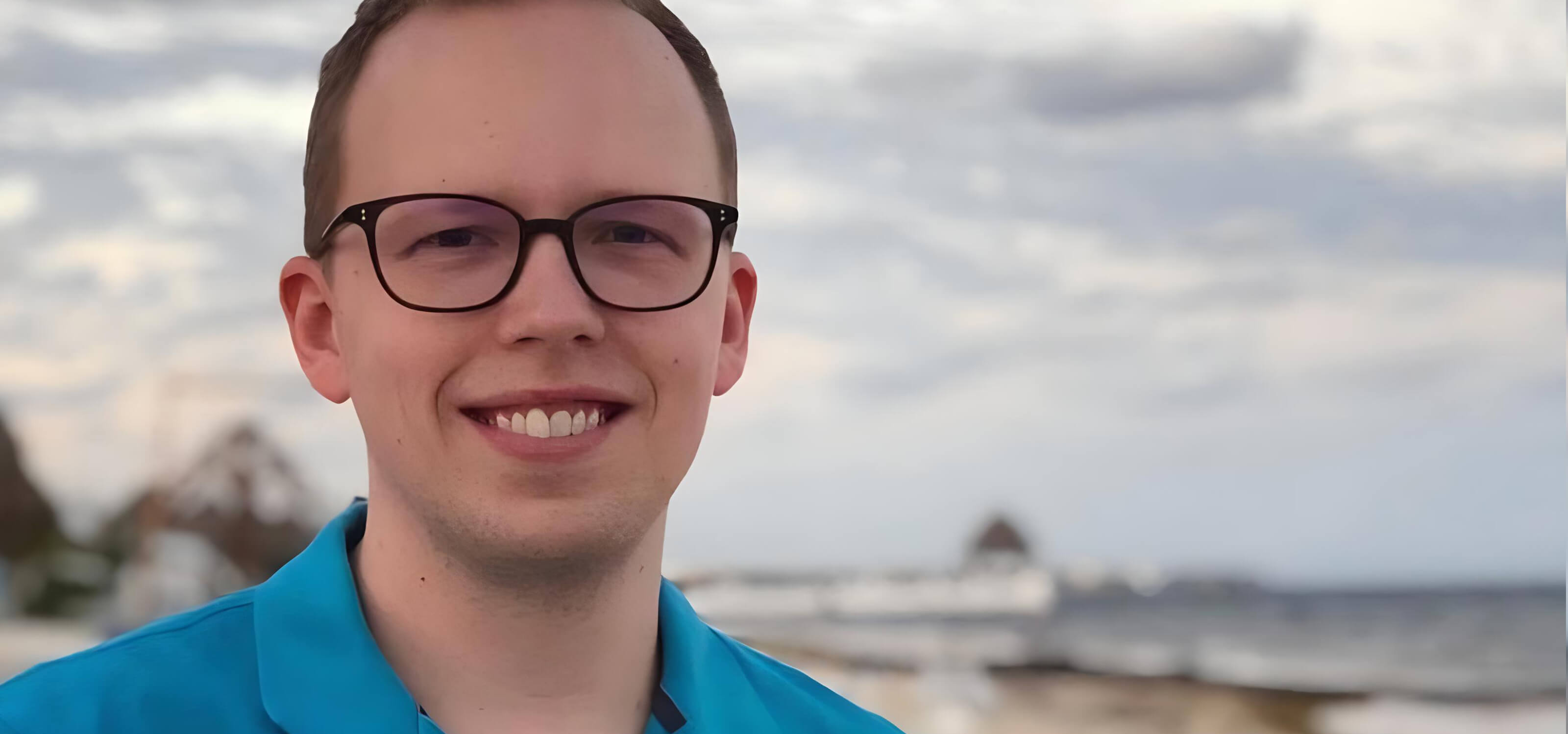 DigiPen graduate Cody Luitjens smiles on a beach.