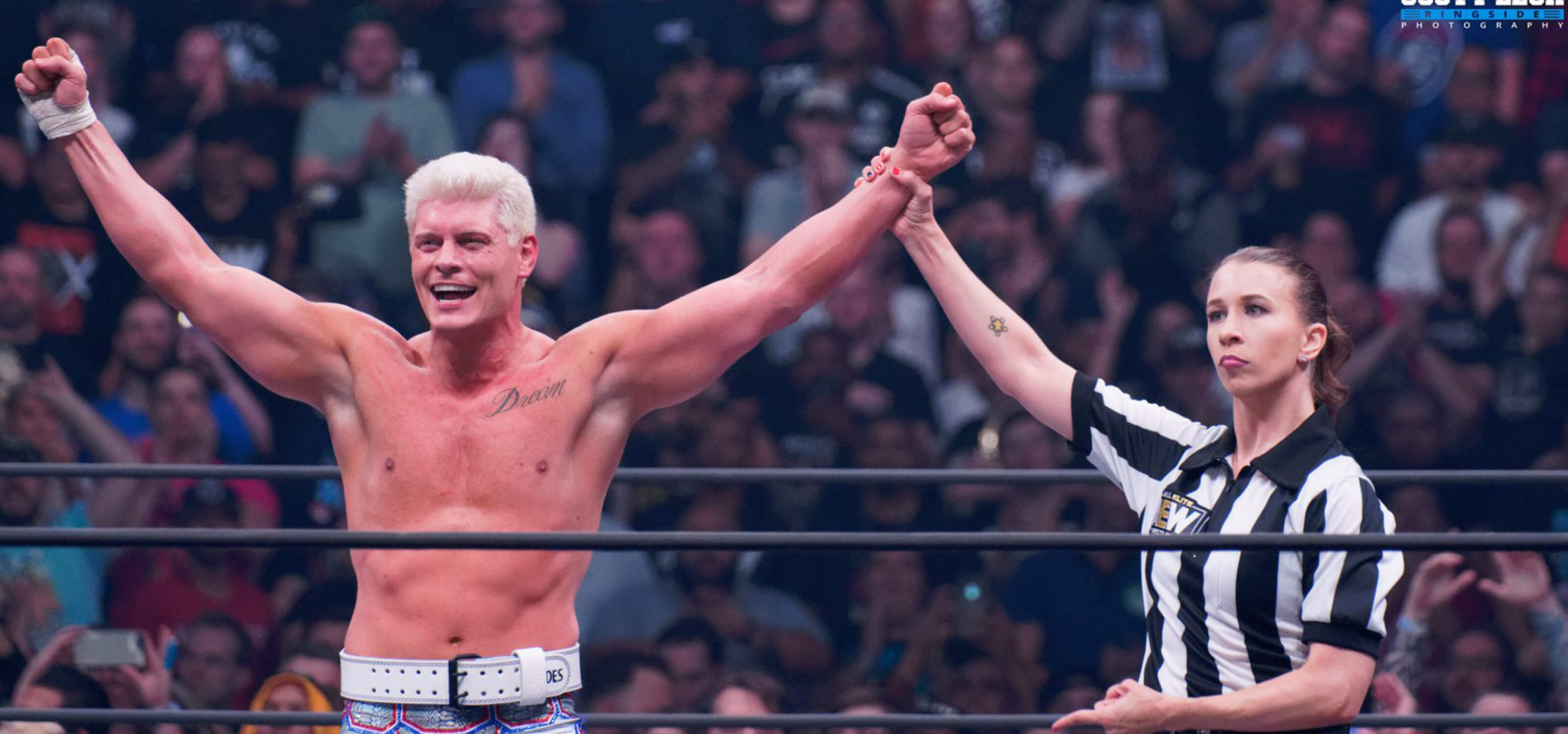 Referee Aubrey Edwards in the ring with AEW wrestler and executive vice president Cody Rhodes.