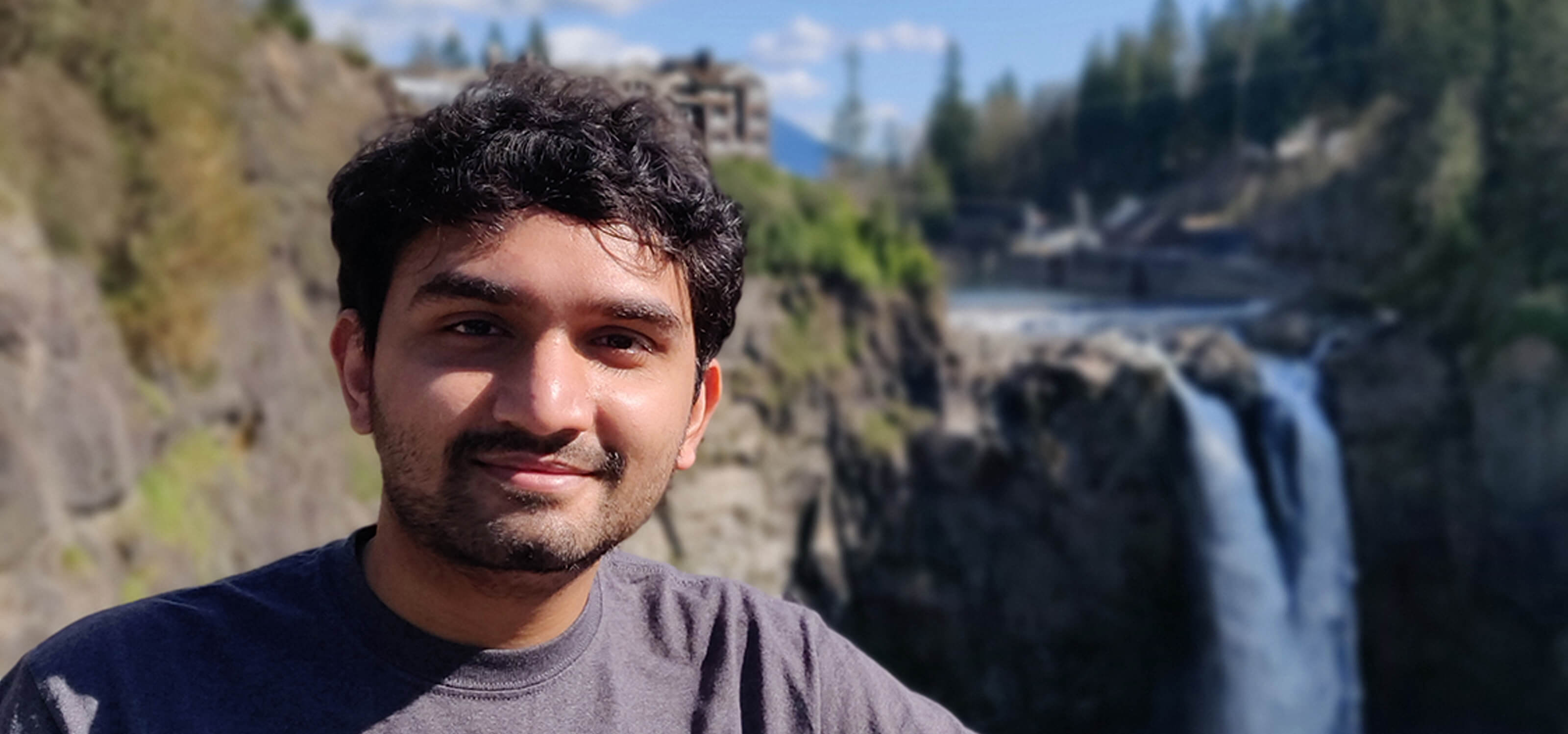 DigiPen MS in Computer Science graduate Dhrumil Shukla poses in front of Snoqualmie Falls