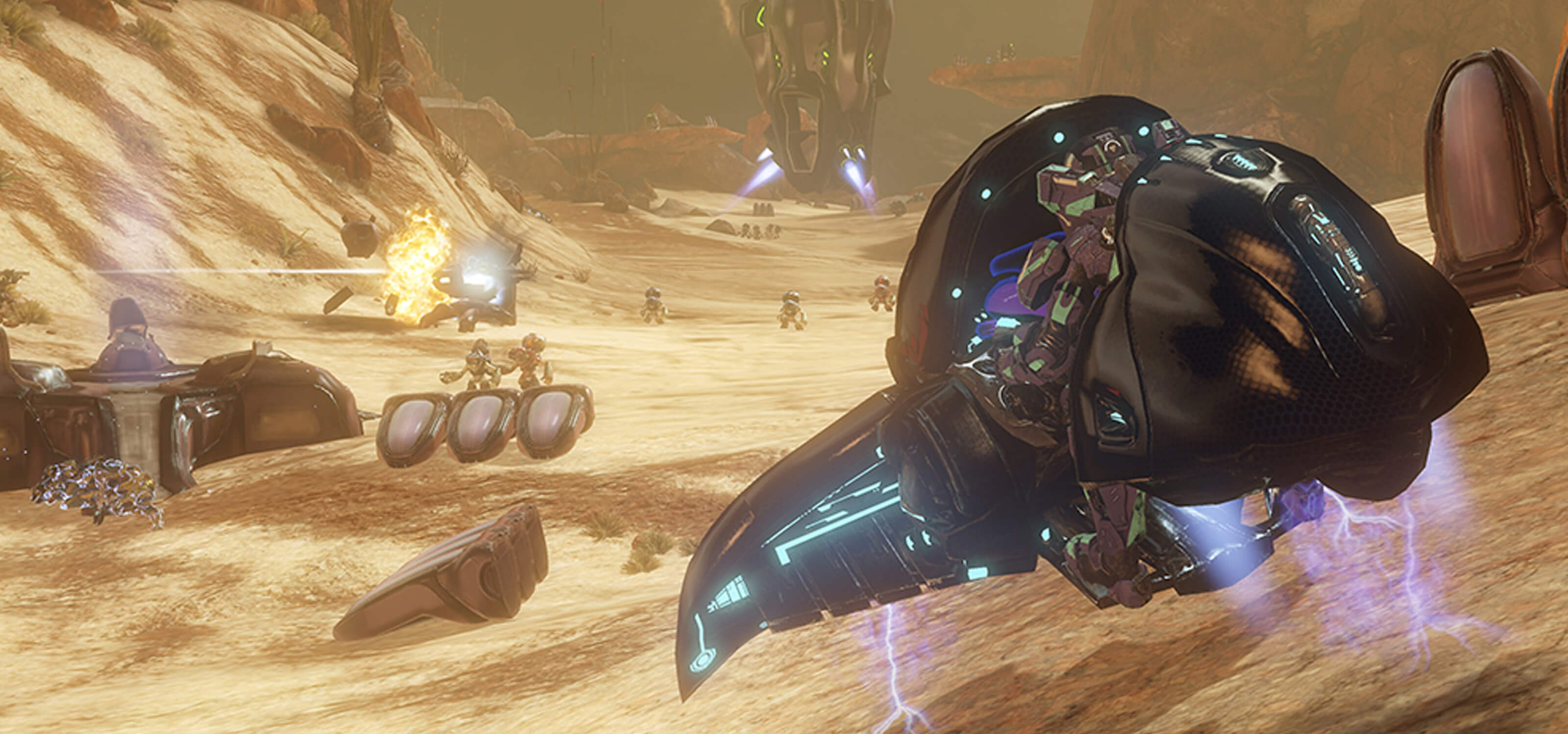 Screenshot from Halo 4 of futuristic machines flying through a mountainous desert