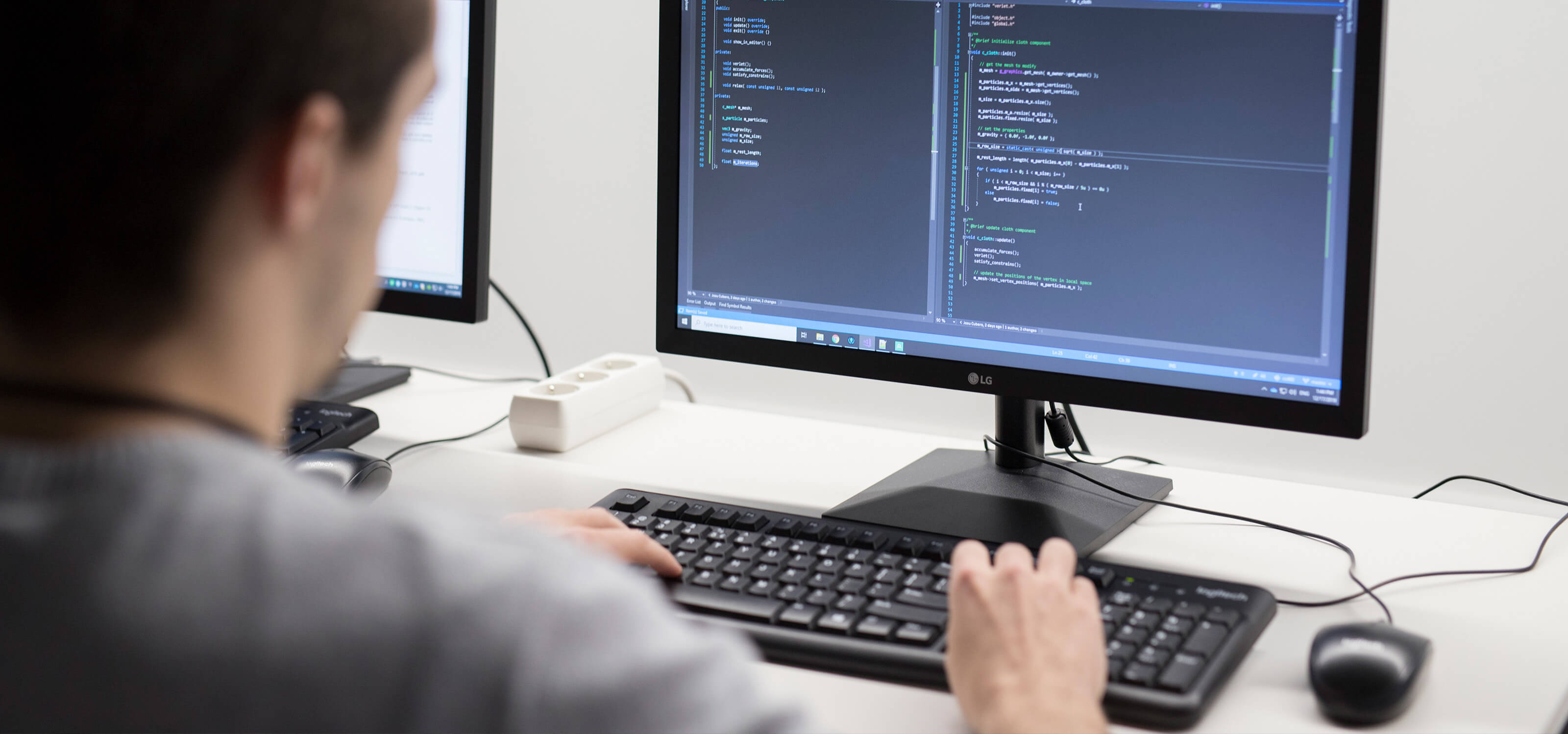 A DigiPen computer science student codes at a computer.