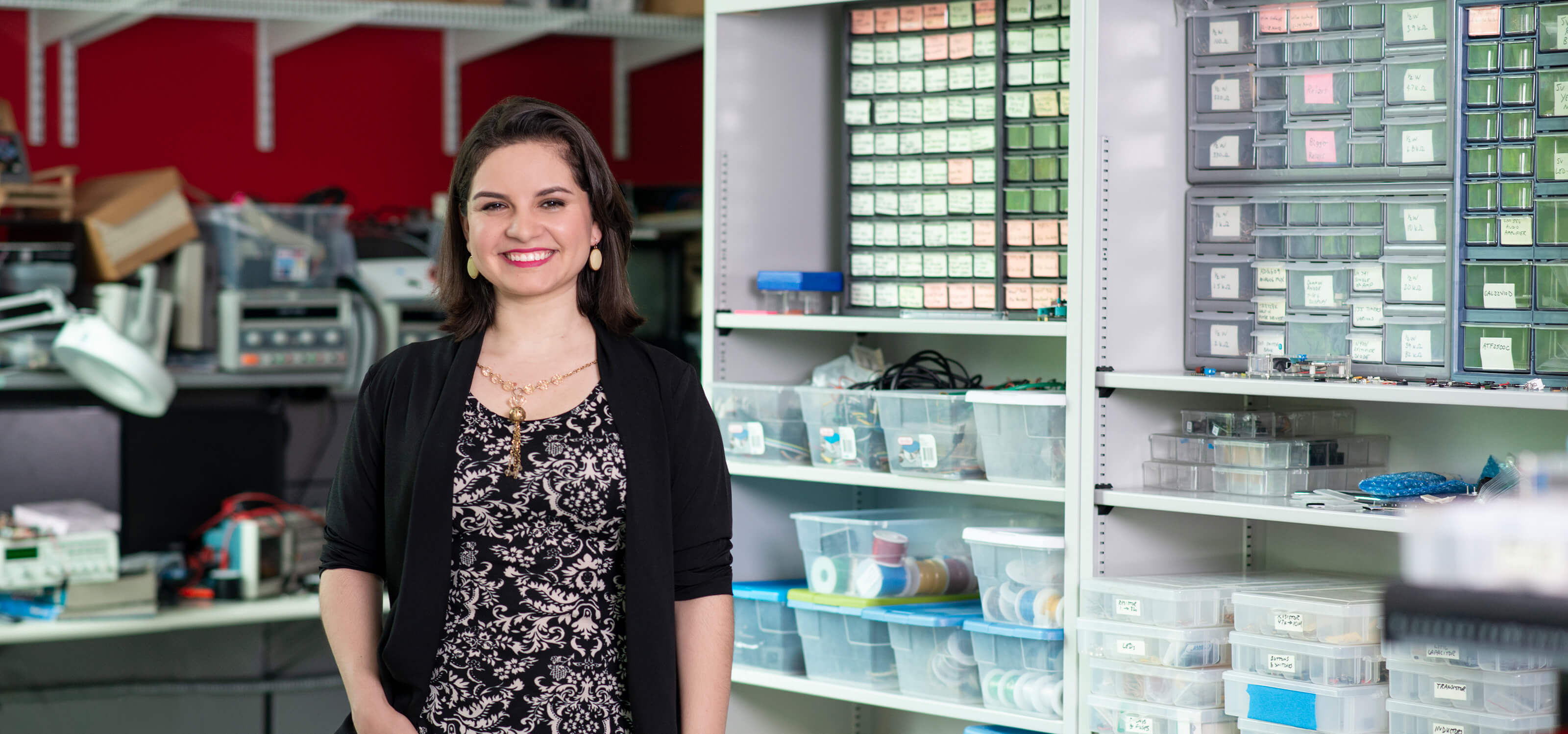 DigiPen professor Lorena Villarreal stands smiling in a DigiPen lab