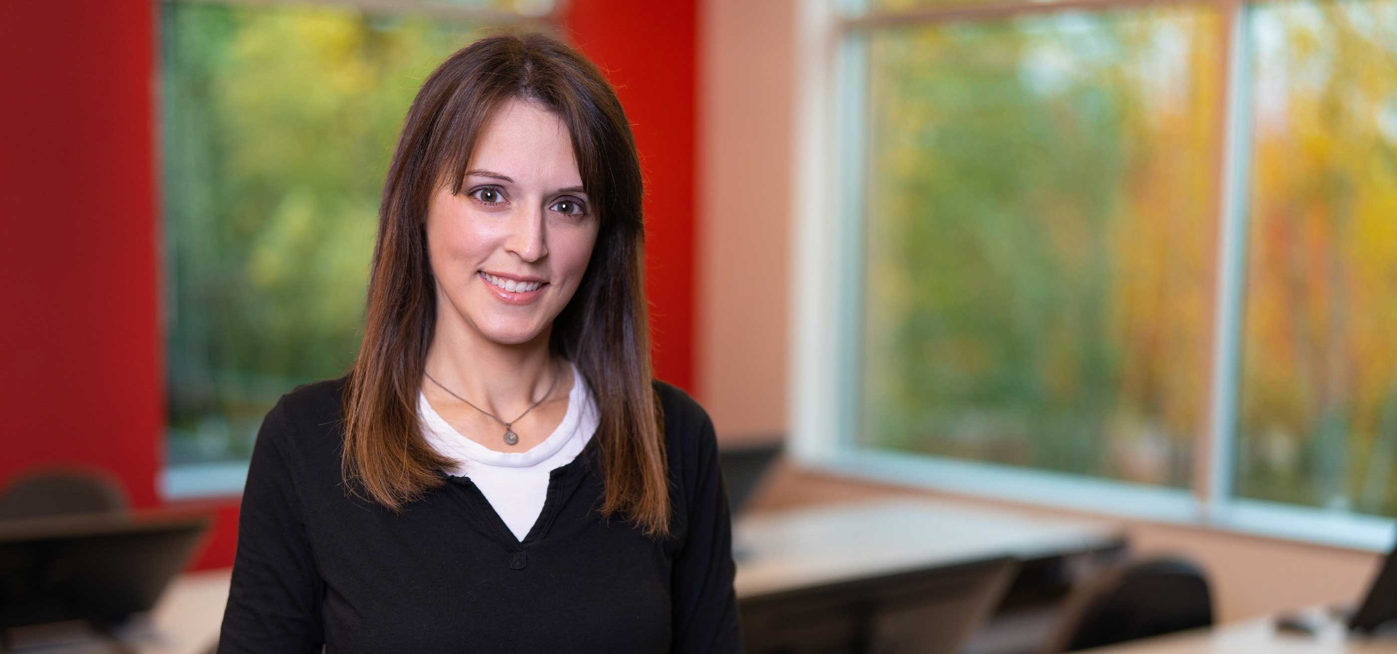 Professor Vanessa Hemovich poses for the camera in a DigiPen classroom..