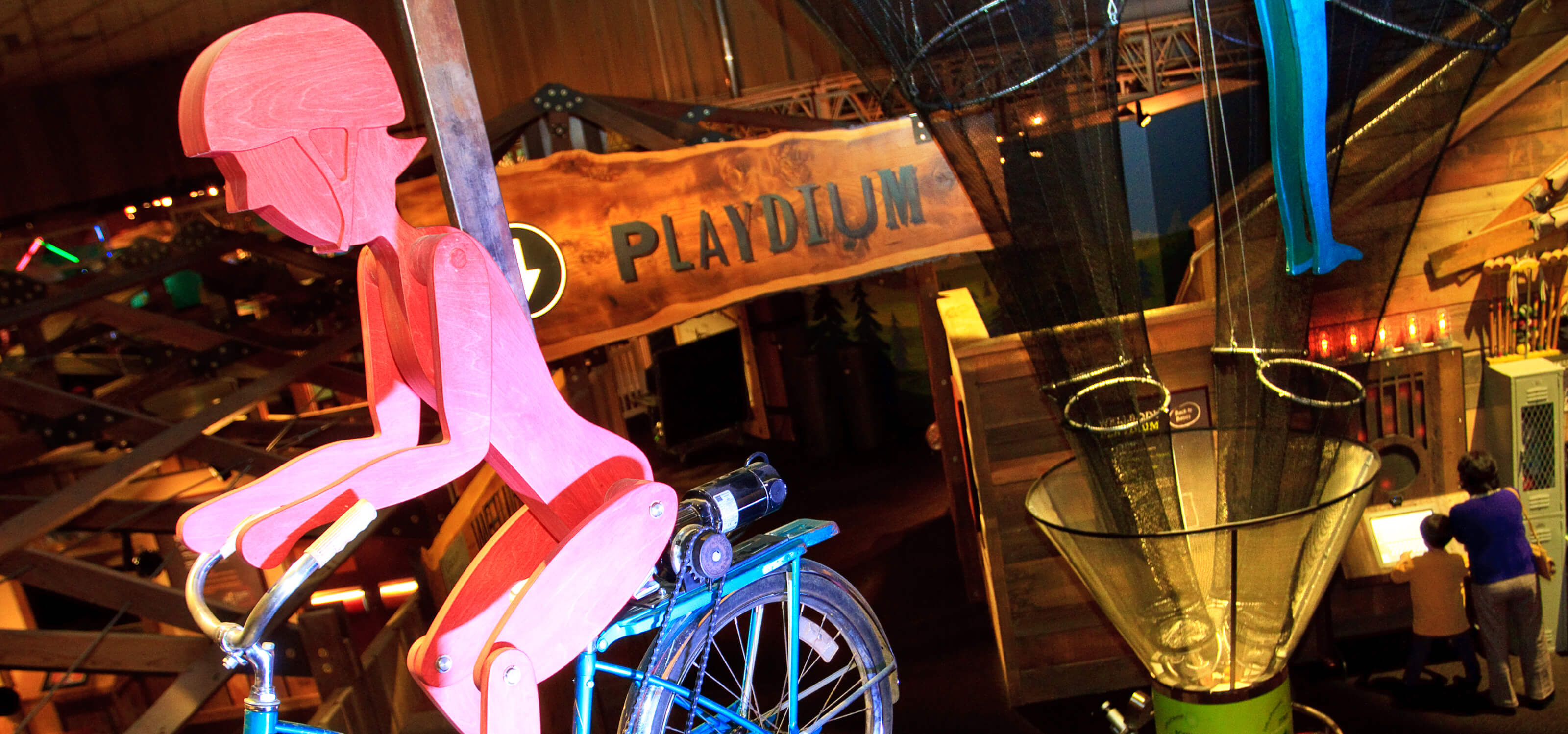 View from above the Playdium section, with a red wooden figure riding a bike in the foreground