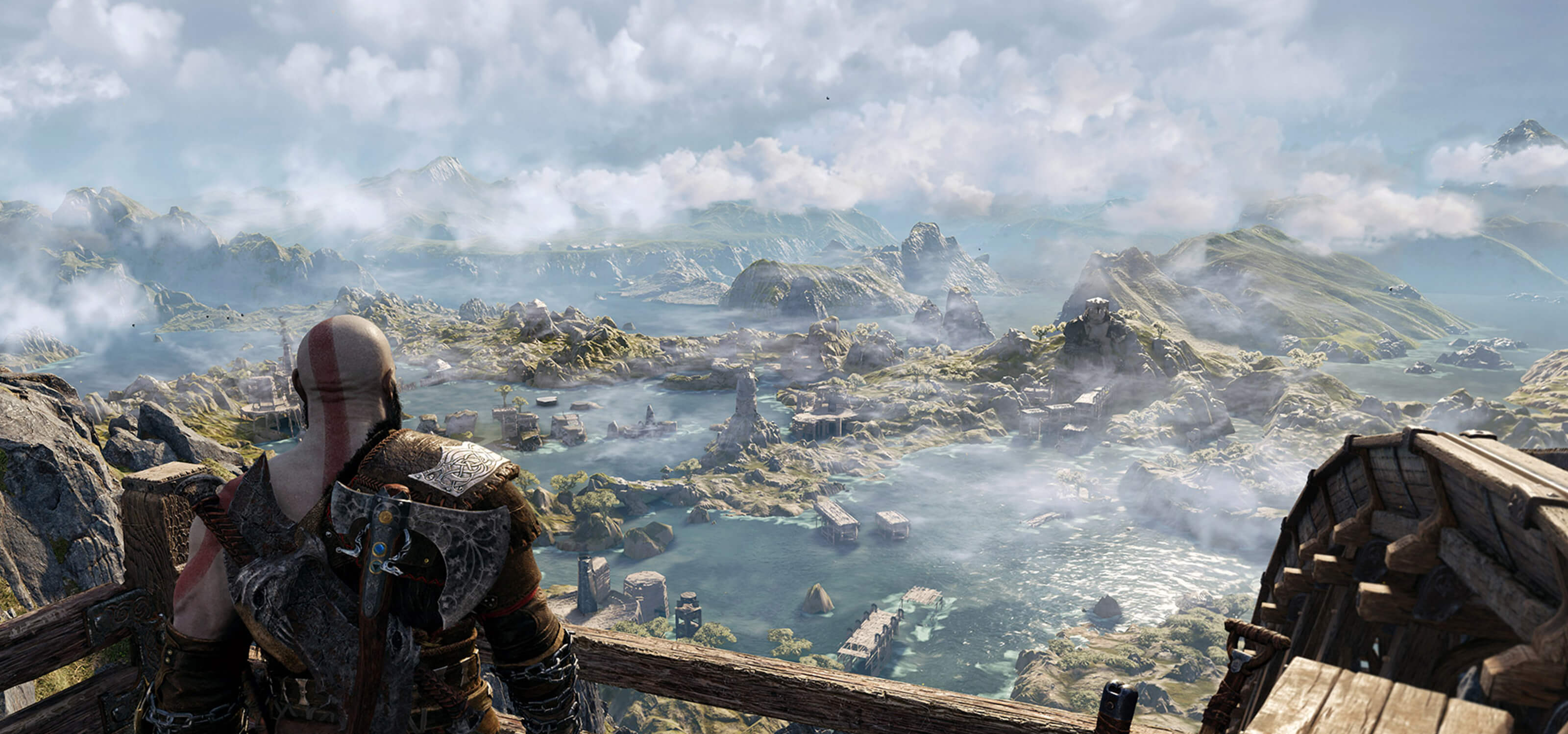 Kratos gazes out on a mountainous lake in God of War Ragnarok.