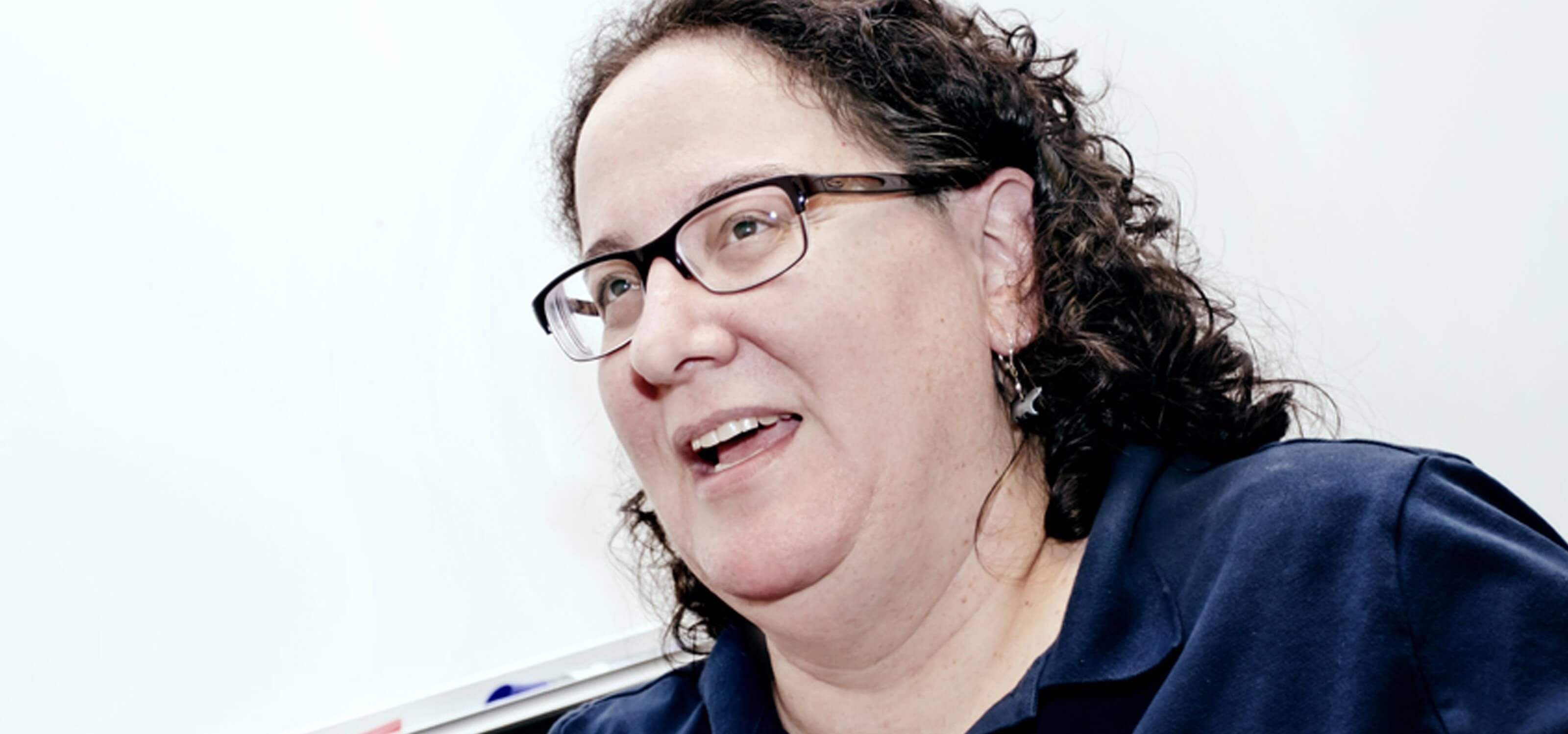 DigiPen professor Ellen Beeman speaking in front of a whiteboard