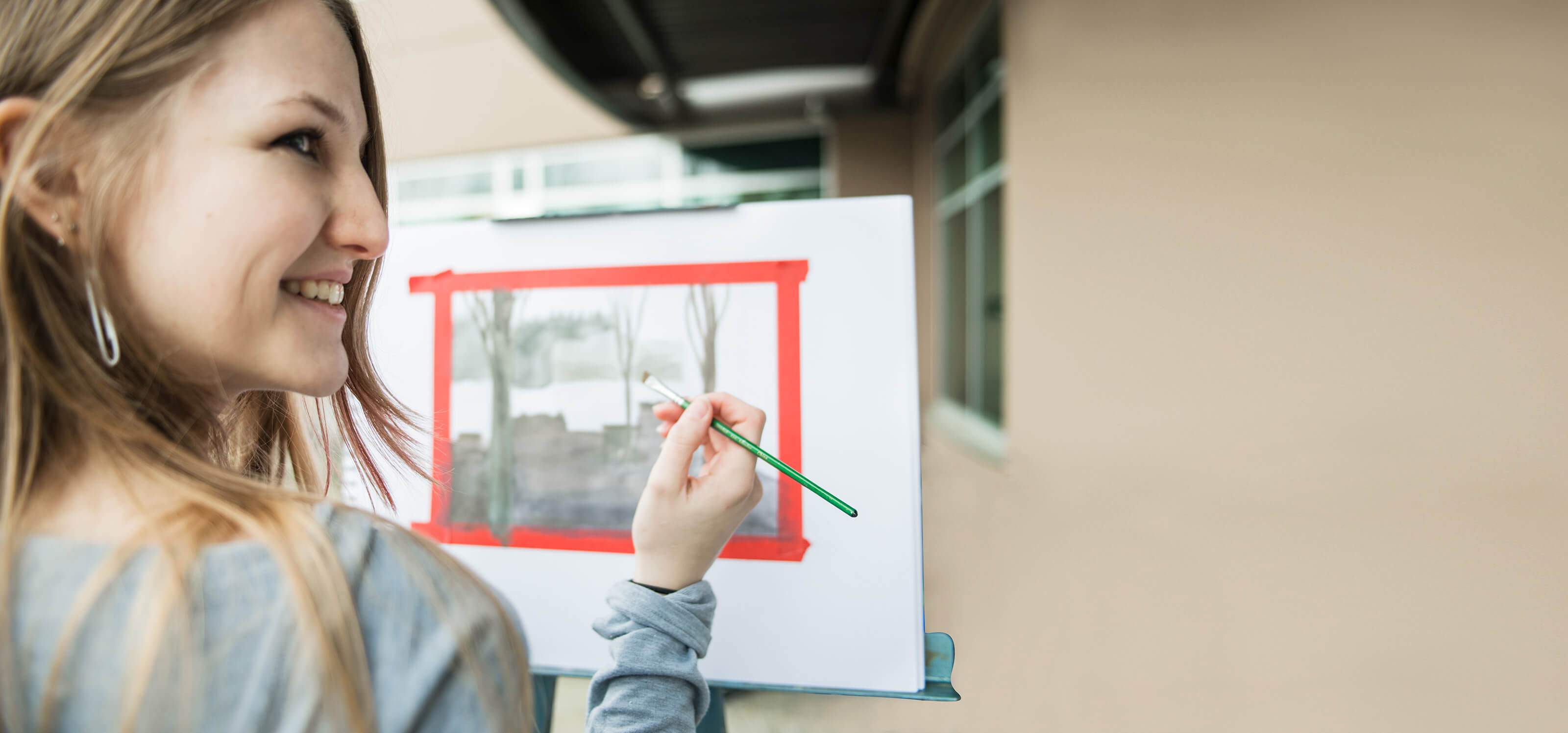 A DigiPen art student paints a watercolor landscape.