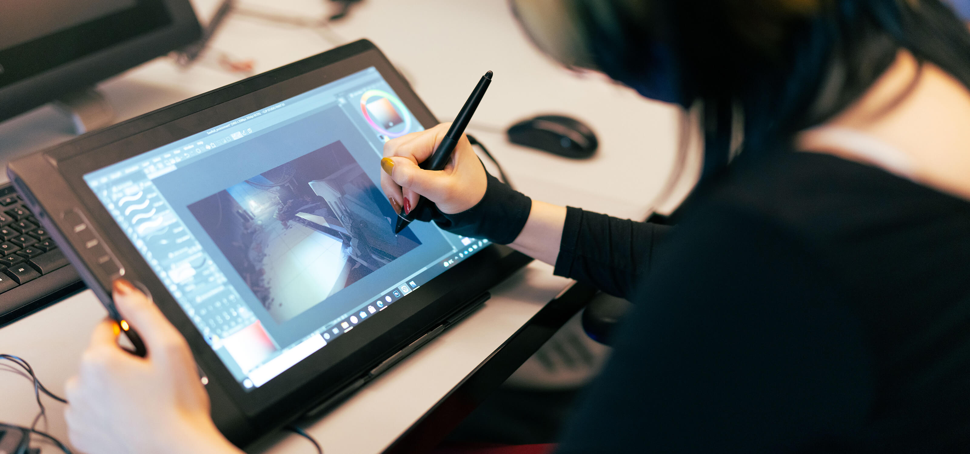 A DigiPen student works on her film team project on her drawing tablet.