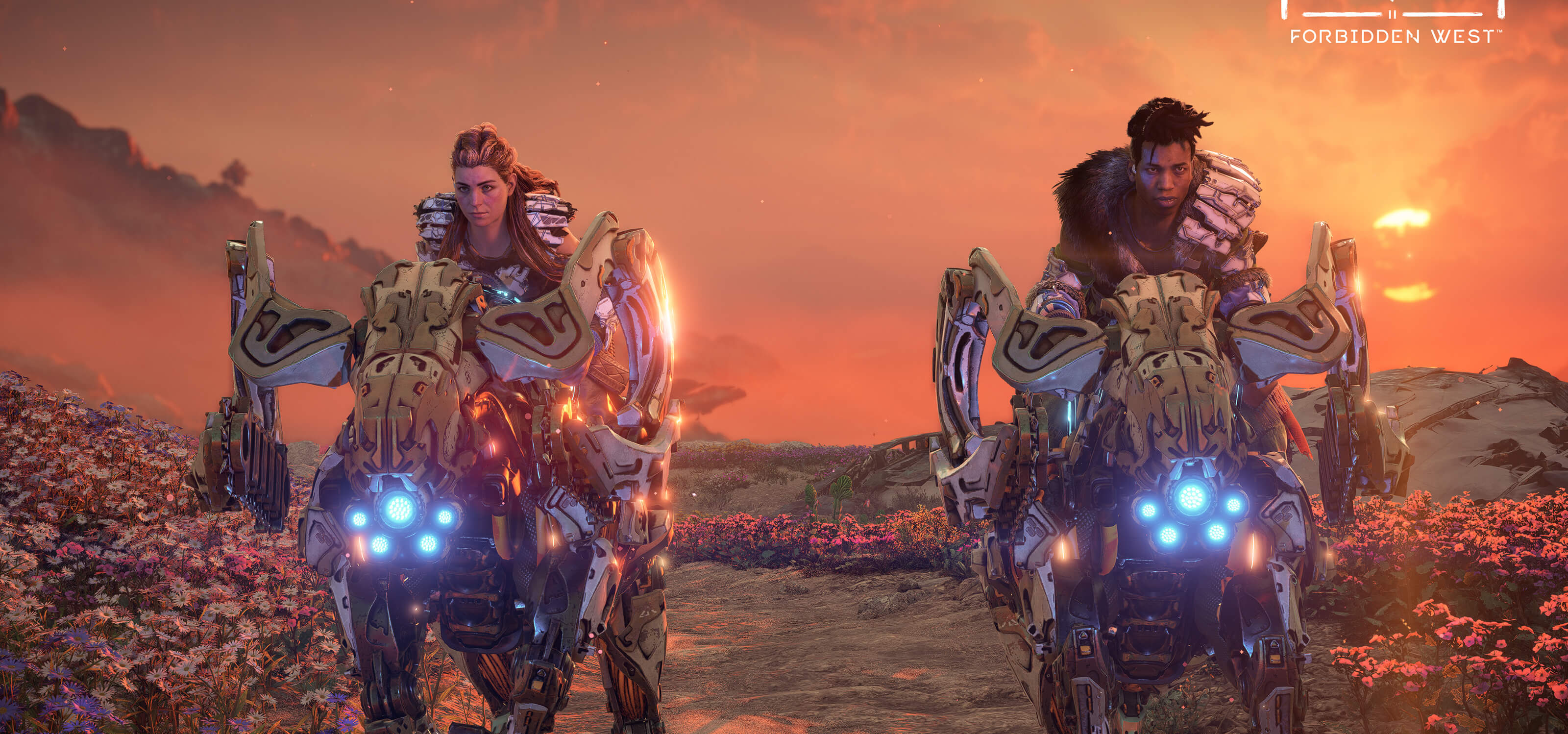 Aloy and Varl from Horizon Forbidden West ride through a red landscape atop ram-like machines. 