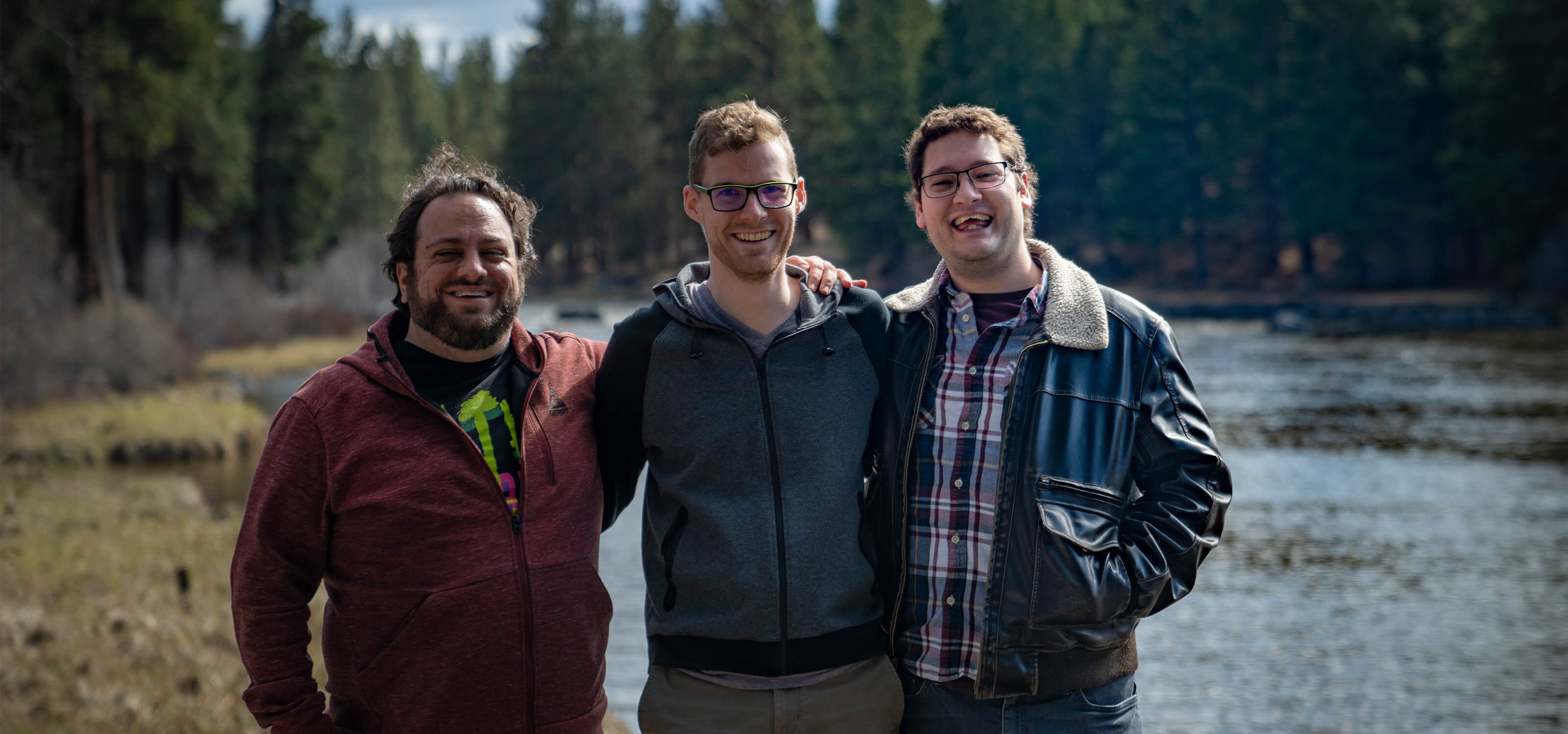 Jacob Fieth, Geoffry Hammon, and Sawyer Paradise pose on the Deschutes River near SIE Bend Studio’s offices.