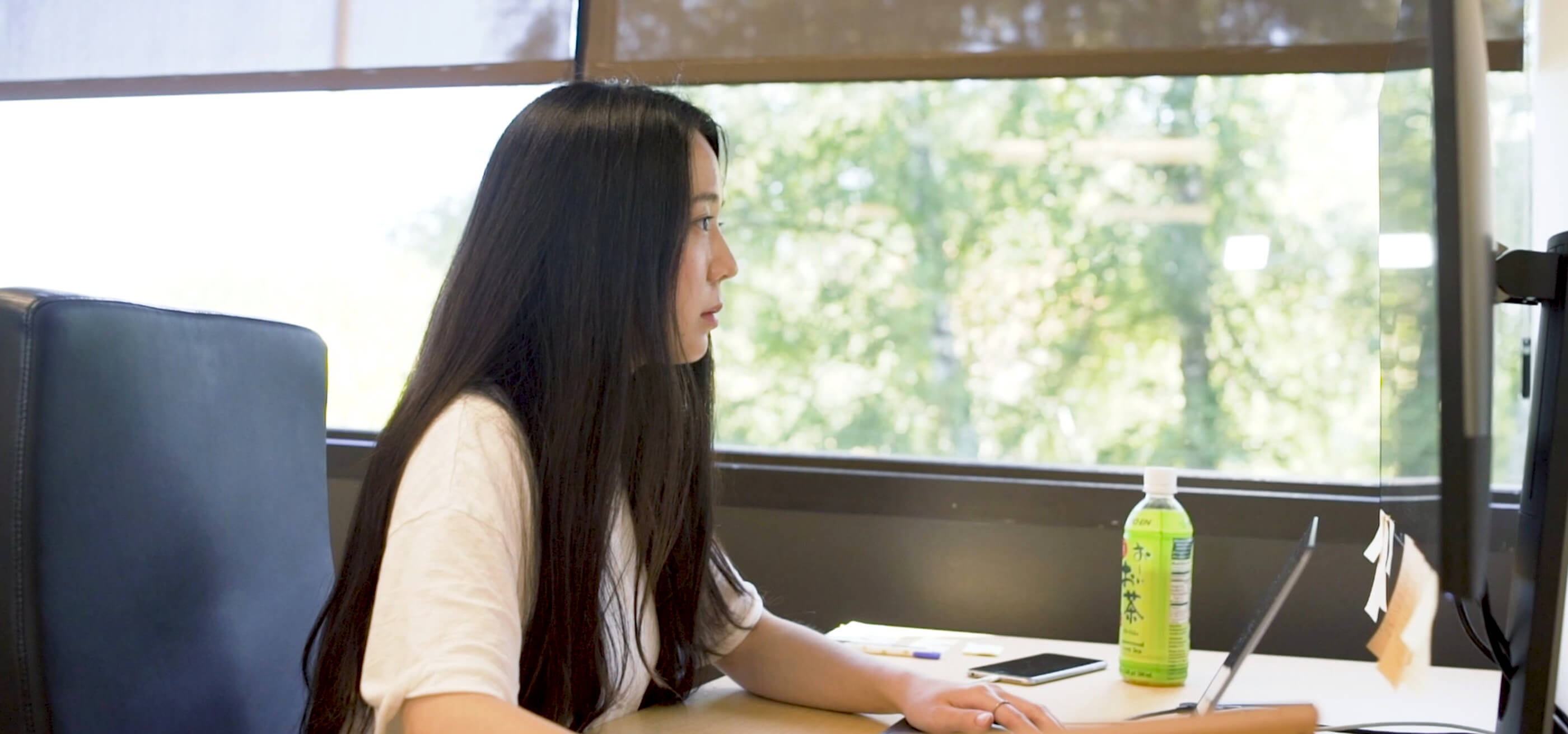 DigiPen grad Jiyun Kang sits at computer workstation