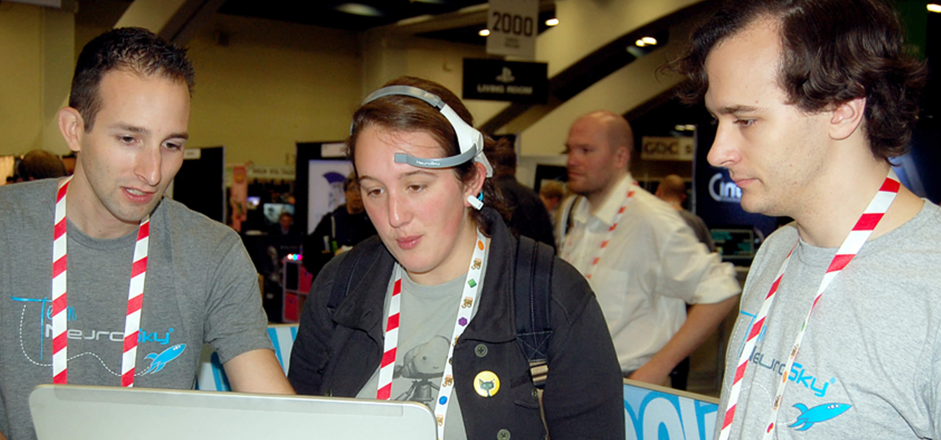 DigiPen alumnus Lat Ware and a colleague explaining their EEG-powered game, Throw Trucks With Your Mind, to a player at GDC