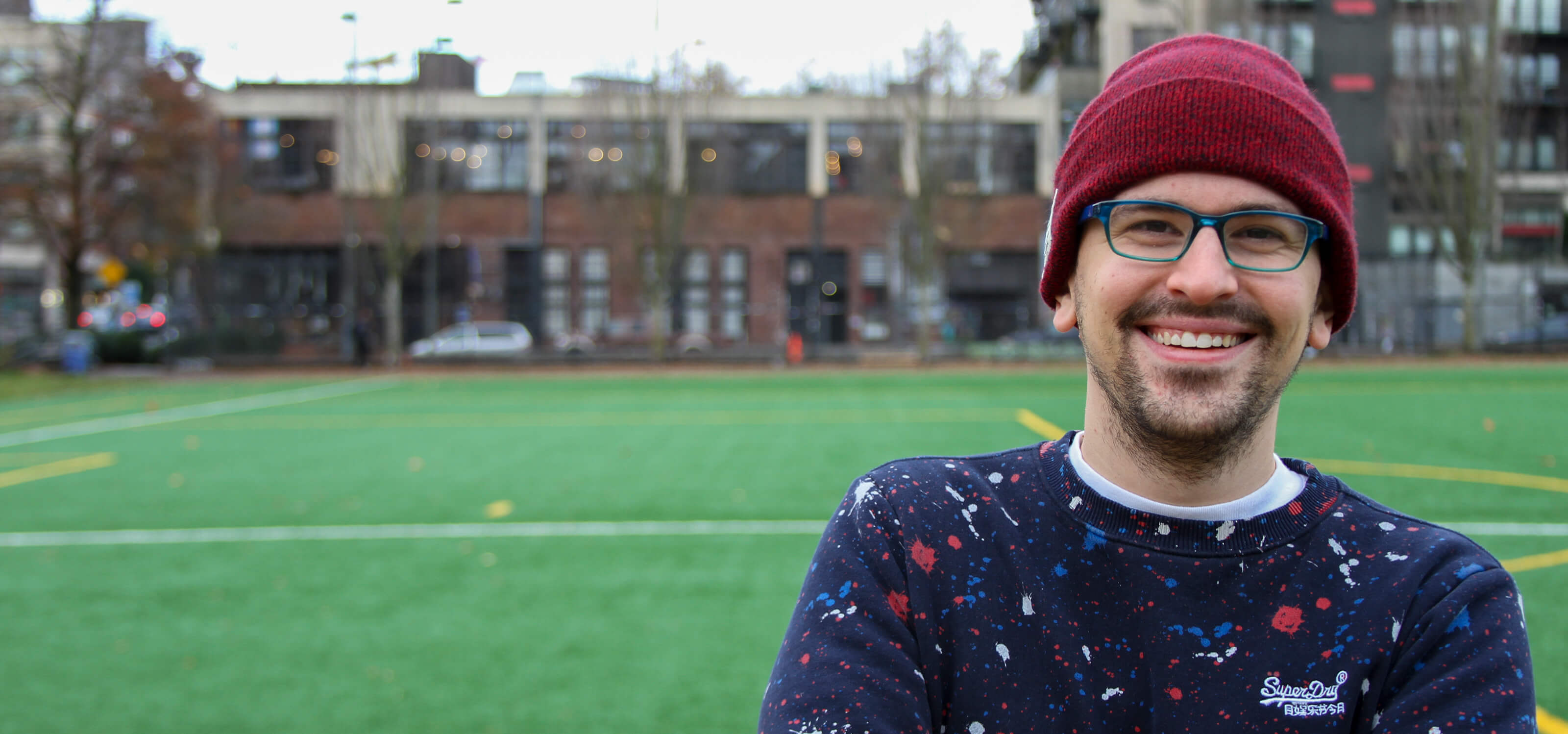 DigiPen game design graduate Logan Fieth smiles for the camera in Seattle’s Cal Anderson Park.