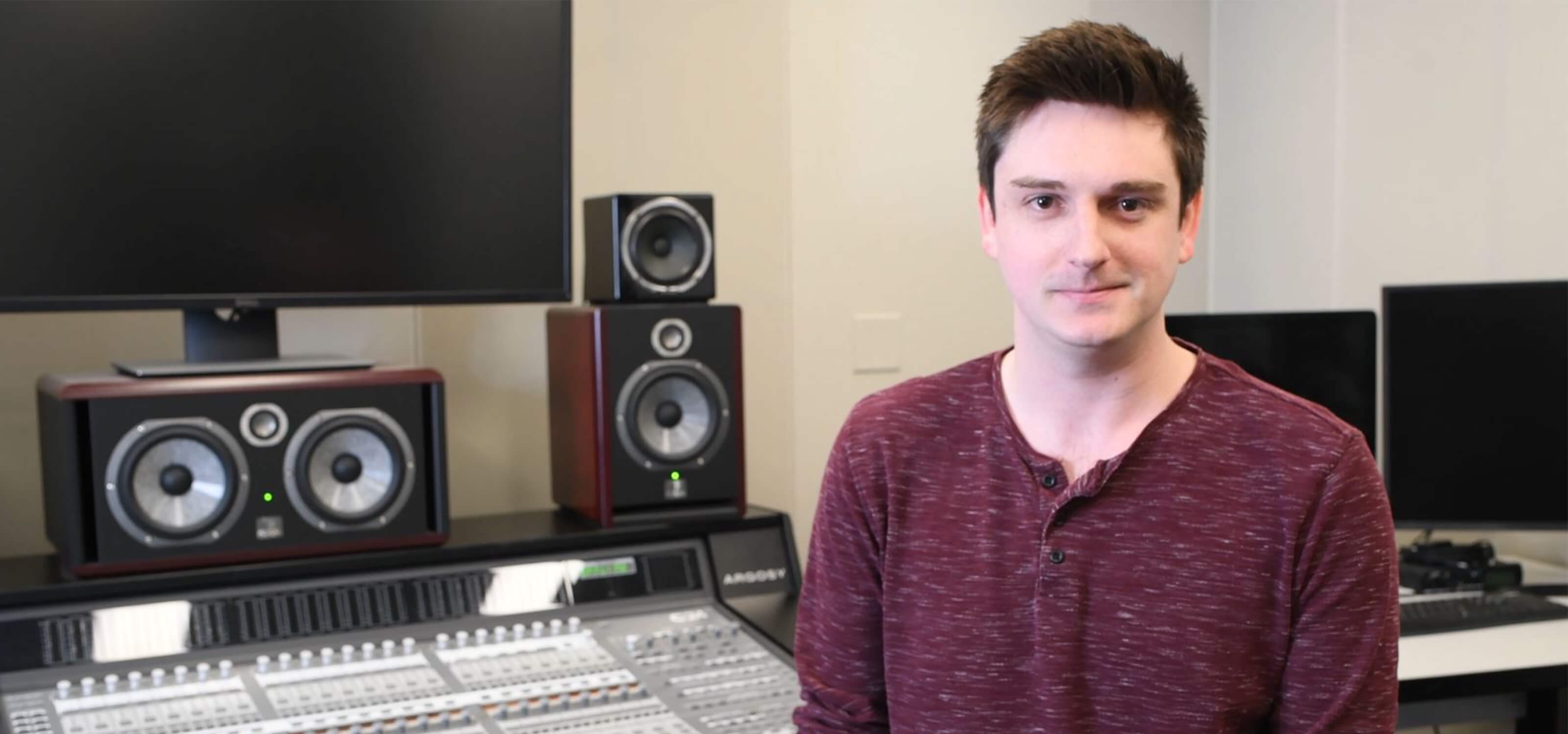 DigiPen graduate Max Hayes smiles in the campus audio lab.