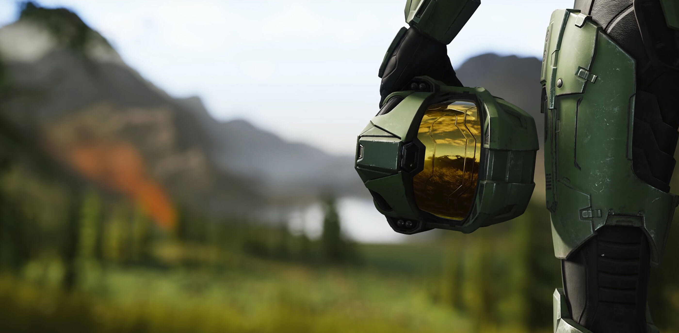 A Halo Infinite screenshot of Master Chief holding his helmet at his waist.