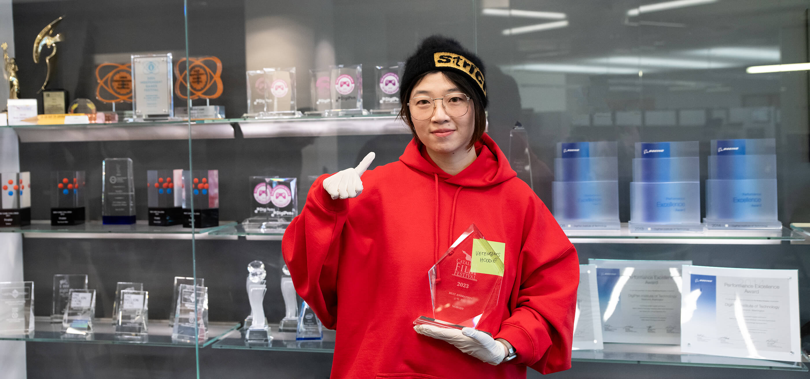Mingyuan Li holds her Catalina Film Festival trophy on campus at DigiPen.