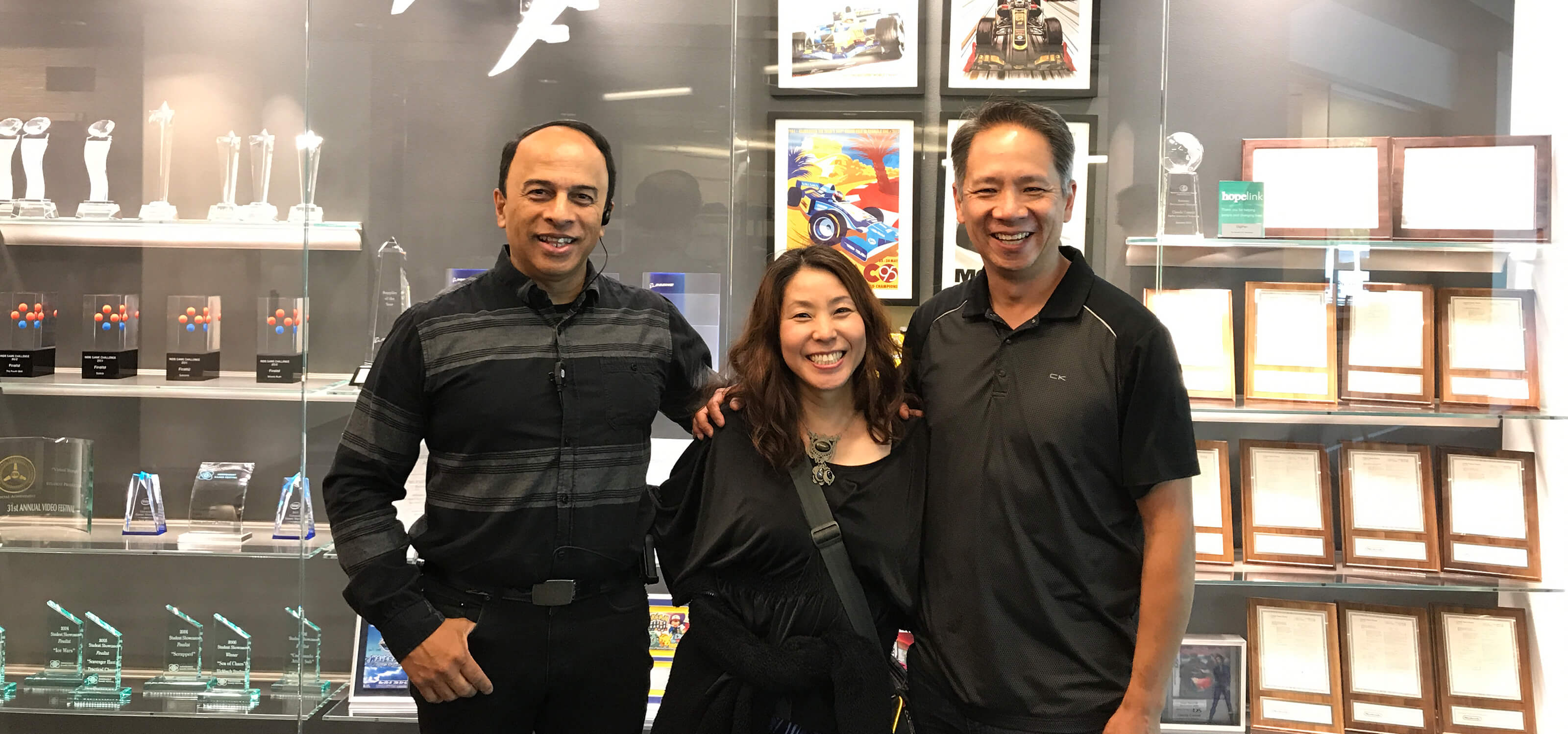 Satomi Asakawa stands next to her former DigiPen professors Ray Yan and Melvin Gonsalvez.