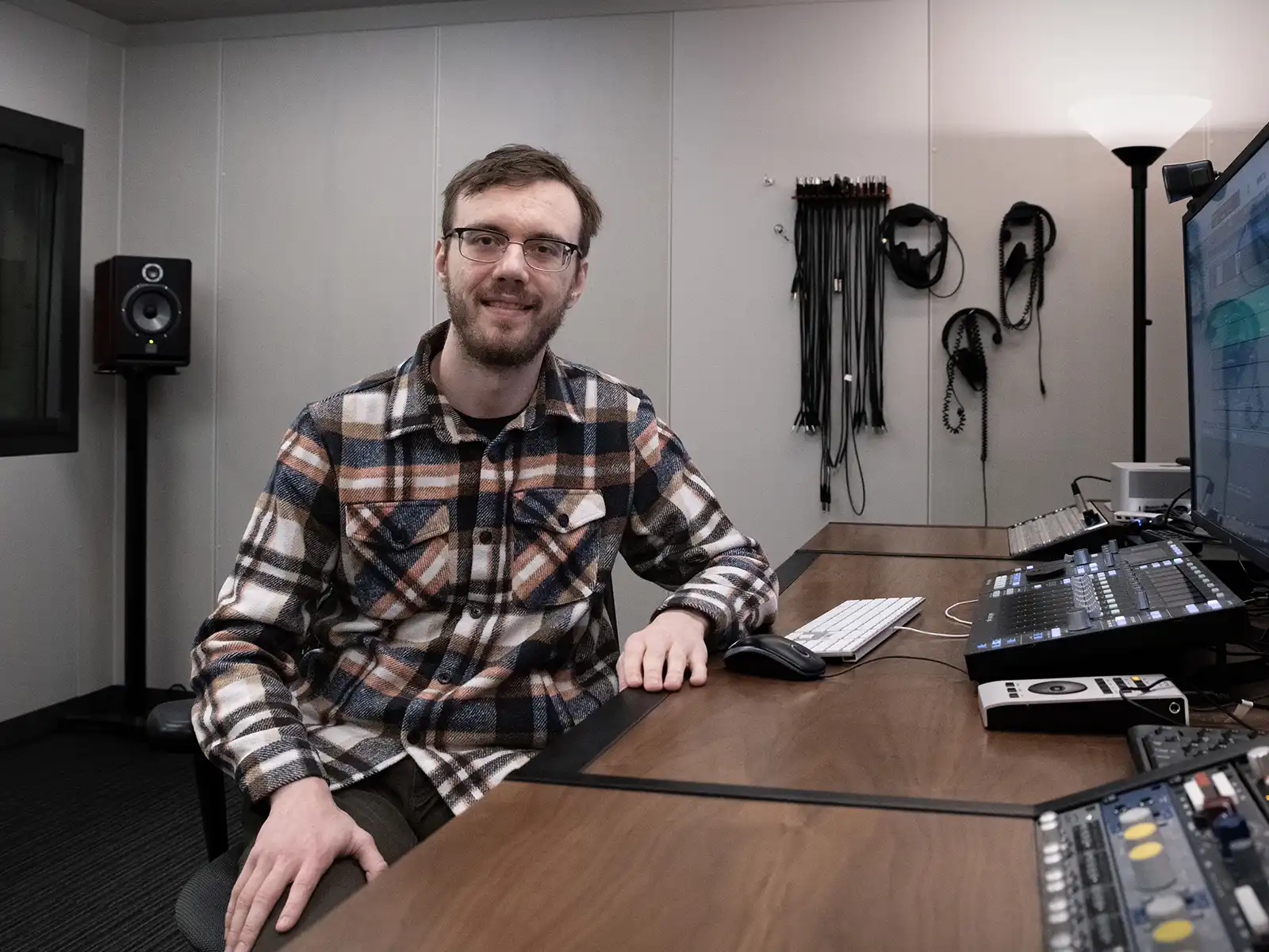 Caleb Klomparens sits at an audio workstation.
