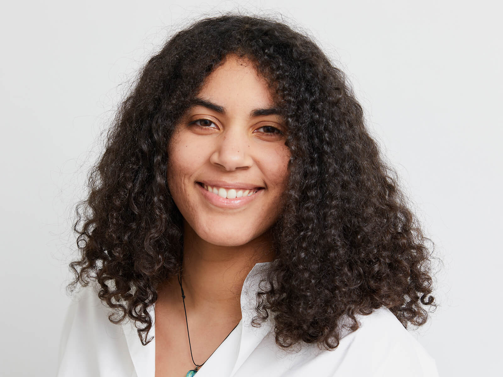 A headshot of DigiPen graduate Apol Vick smiling against a white background.