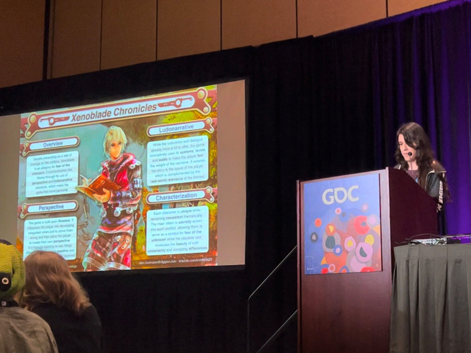 Ellen Heitmann presents her narrative analysis on Xenoblade Chronicles on stage at the GDC Game Narrative Summit.