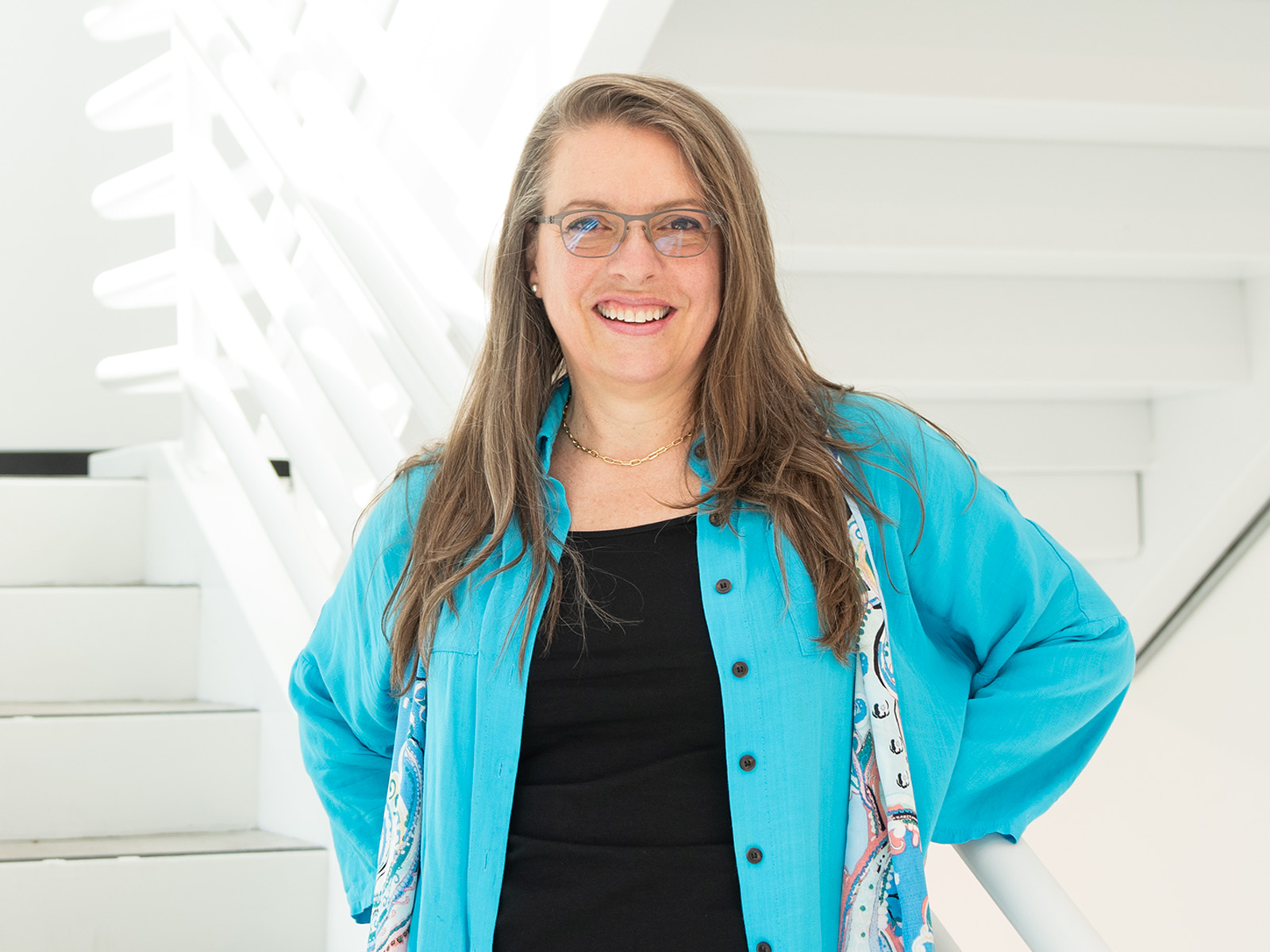 Brigitte Samson stands and smiles inside the DigiPen building.