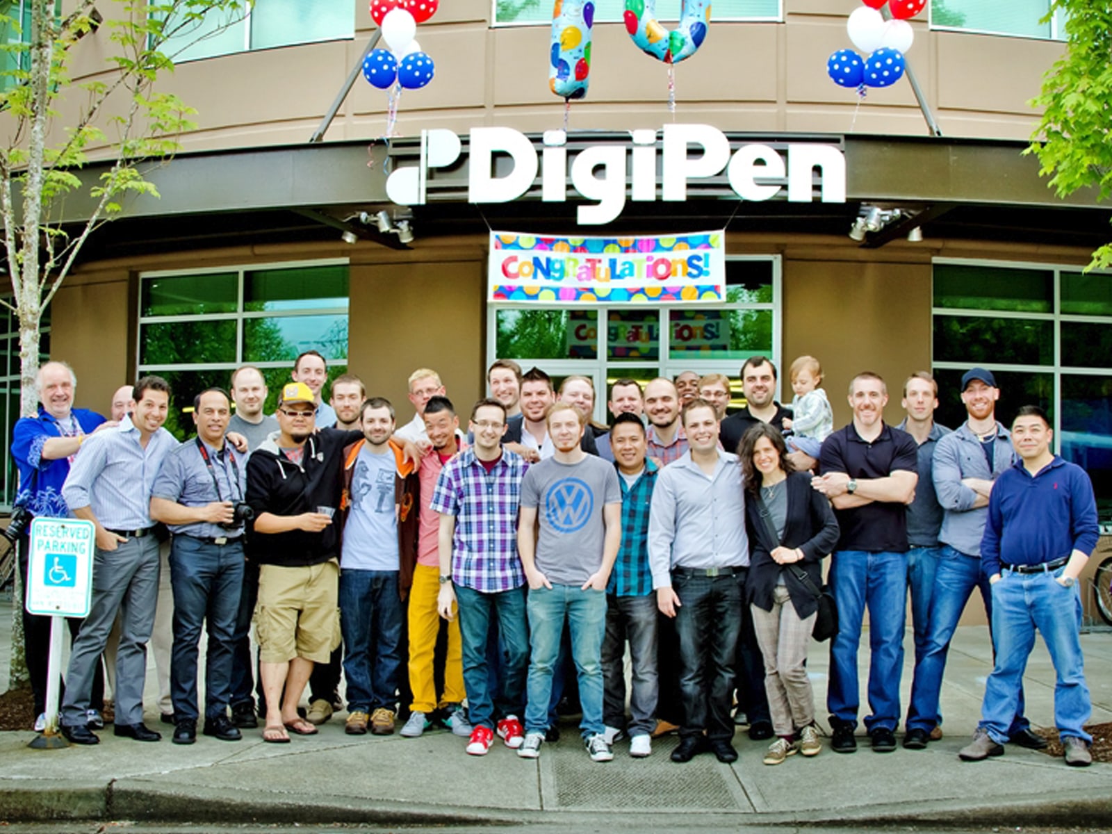 Group photo of 2003 AA in 3D Computer Animation program graduates in front of the DigiPen building