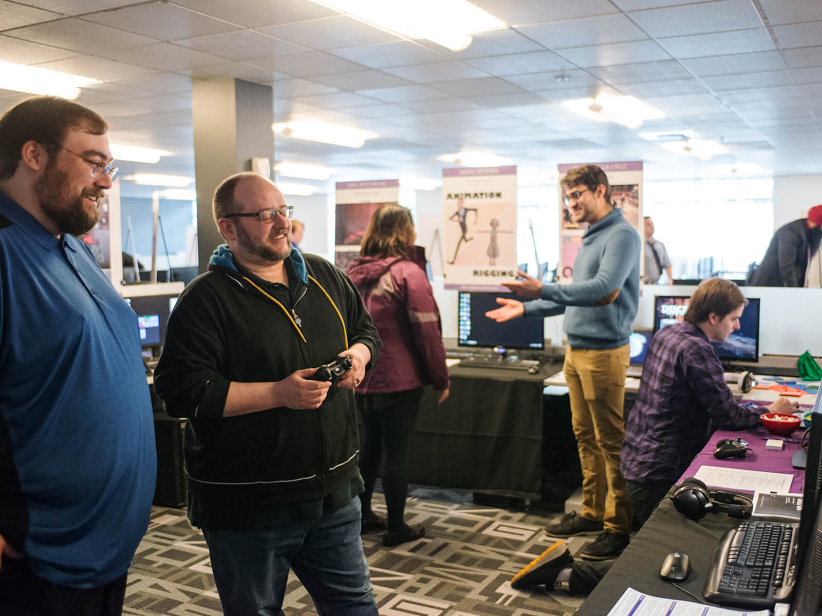 Two employers playing a student game at the 2018 DigiPen Career Fair