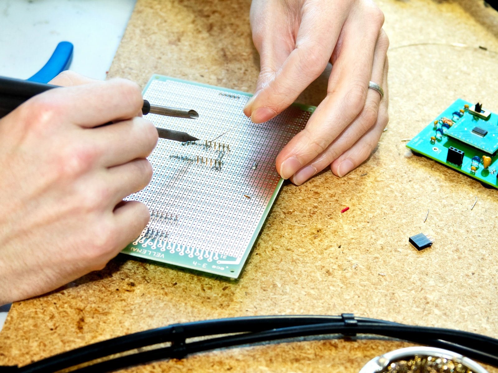 Close-up of a DigiPen student doing detailed work on a small circuit board