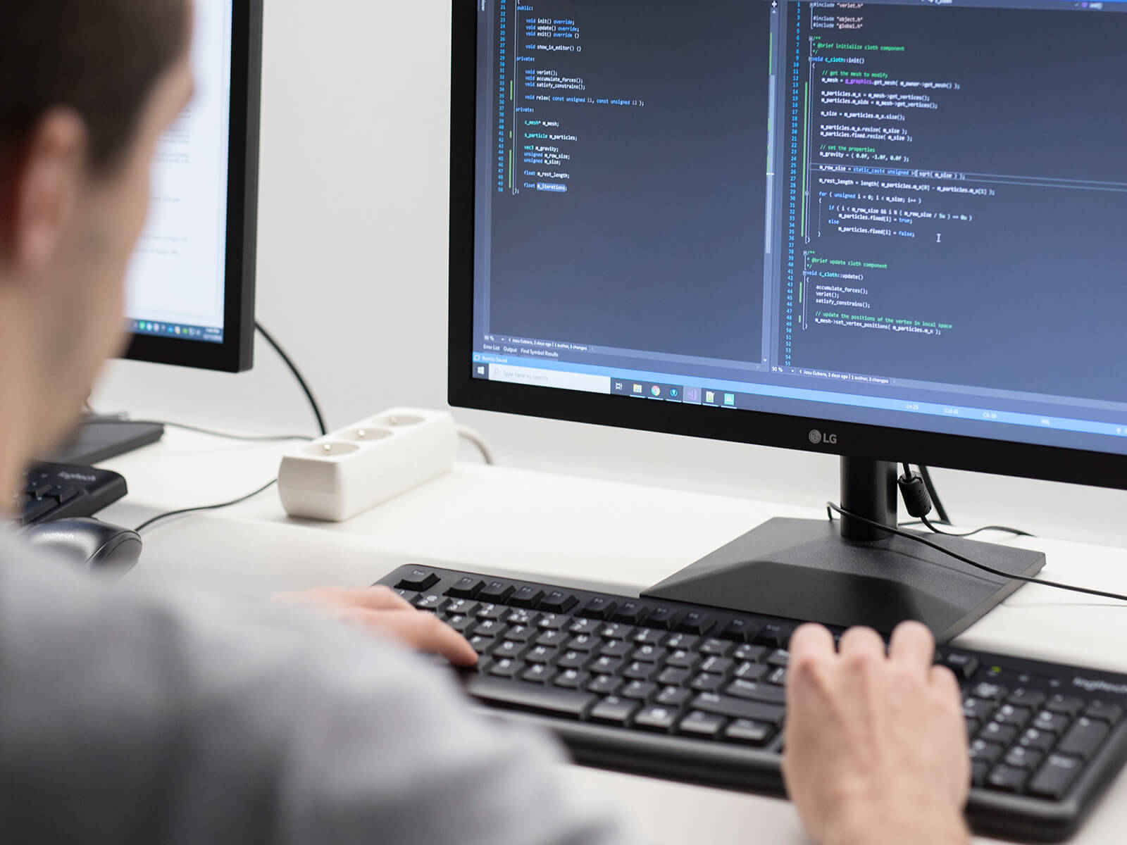 A DigiPen computer science student codes at a computer.