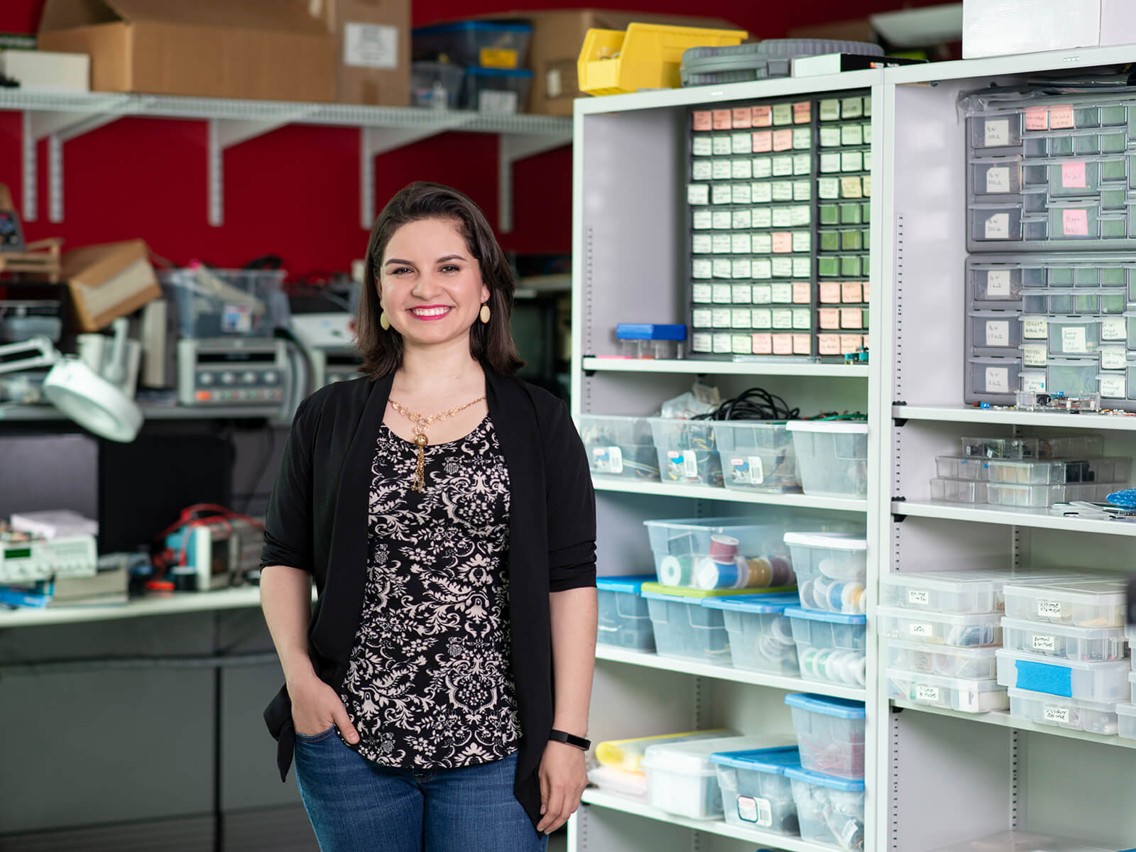 DigiPen professor Lorena Villarreal stands smiling in a DigiPen lab