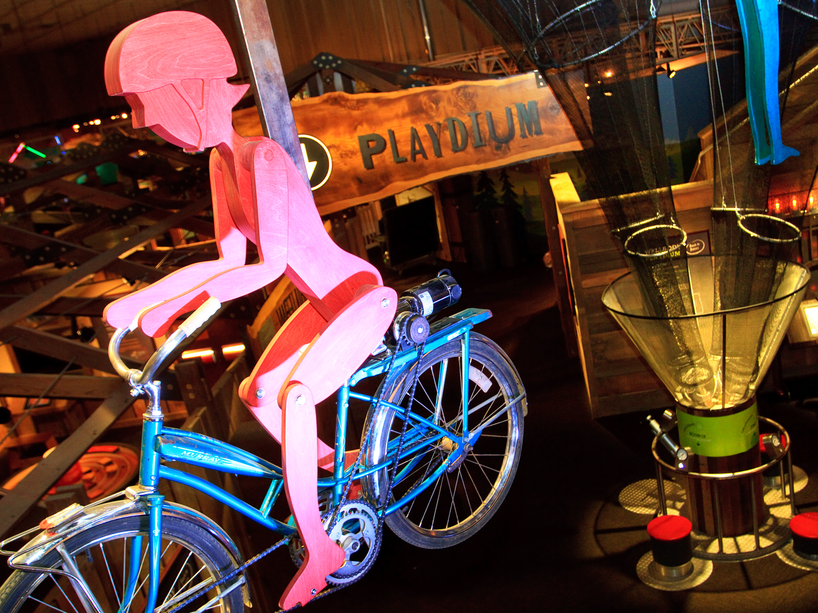 View from above the Playdium section, with a red wooden figure riding a bike in the foreground