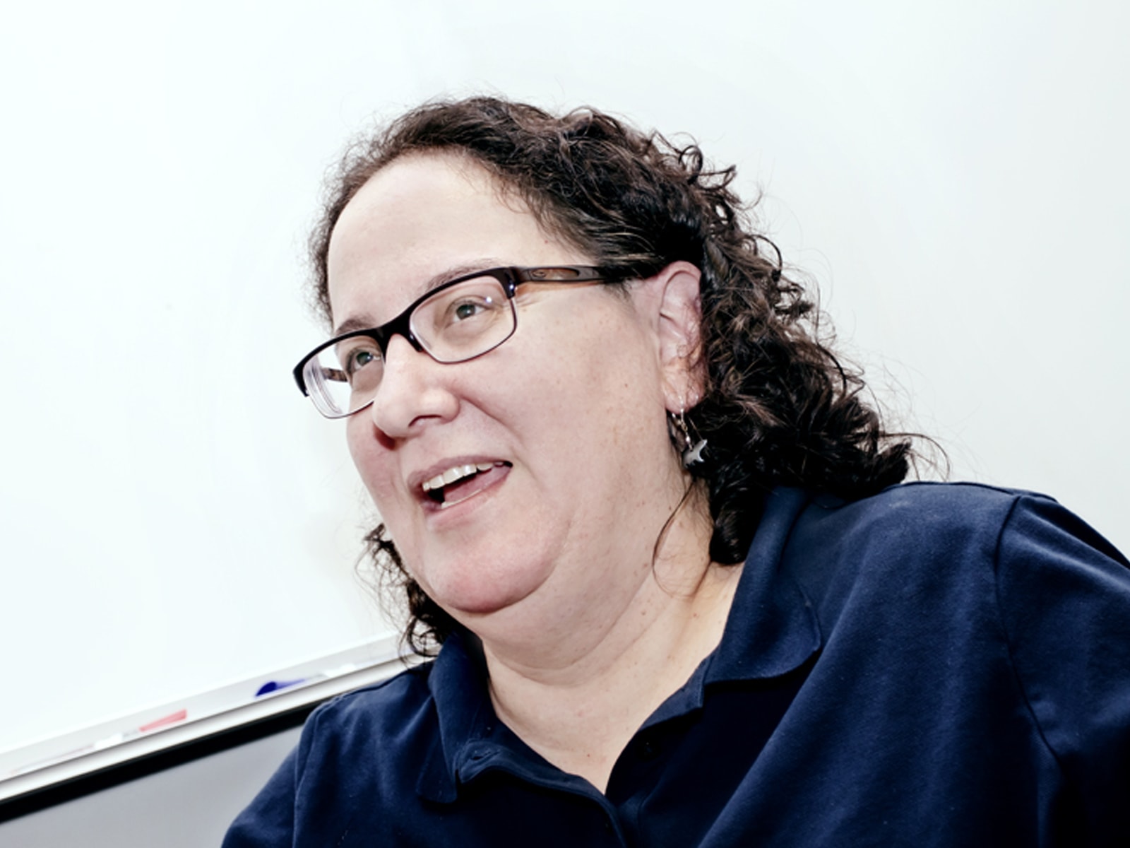 DigiPen professor Ellen Beeman speaking in front of a whiteboard